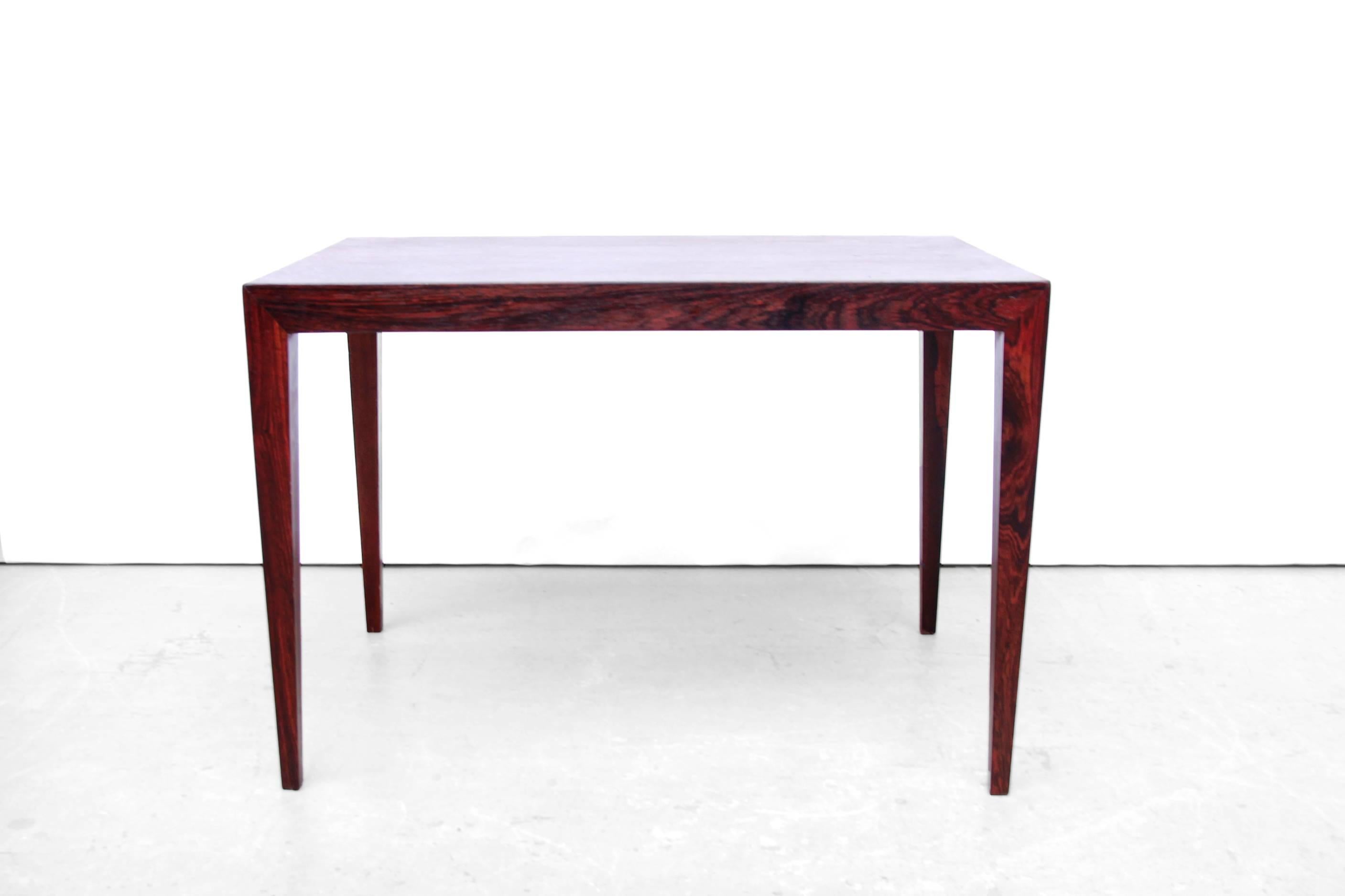 Very nice and subtle side table or small coffee table designed by Severin Hansen jr for Haslev Møbelfabrik. Beatiful grained rosewood, nicely finished. 
The table is made of rosewood veneer with beautiful geometric connection of the legs to the
