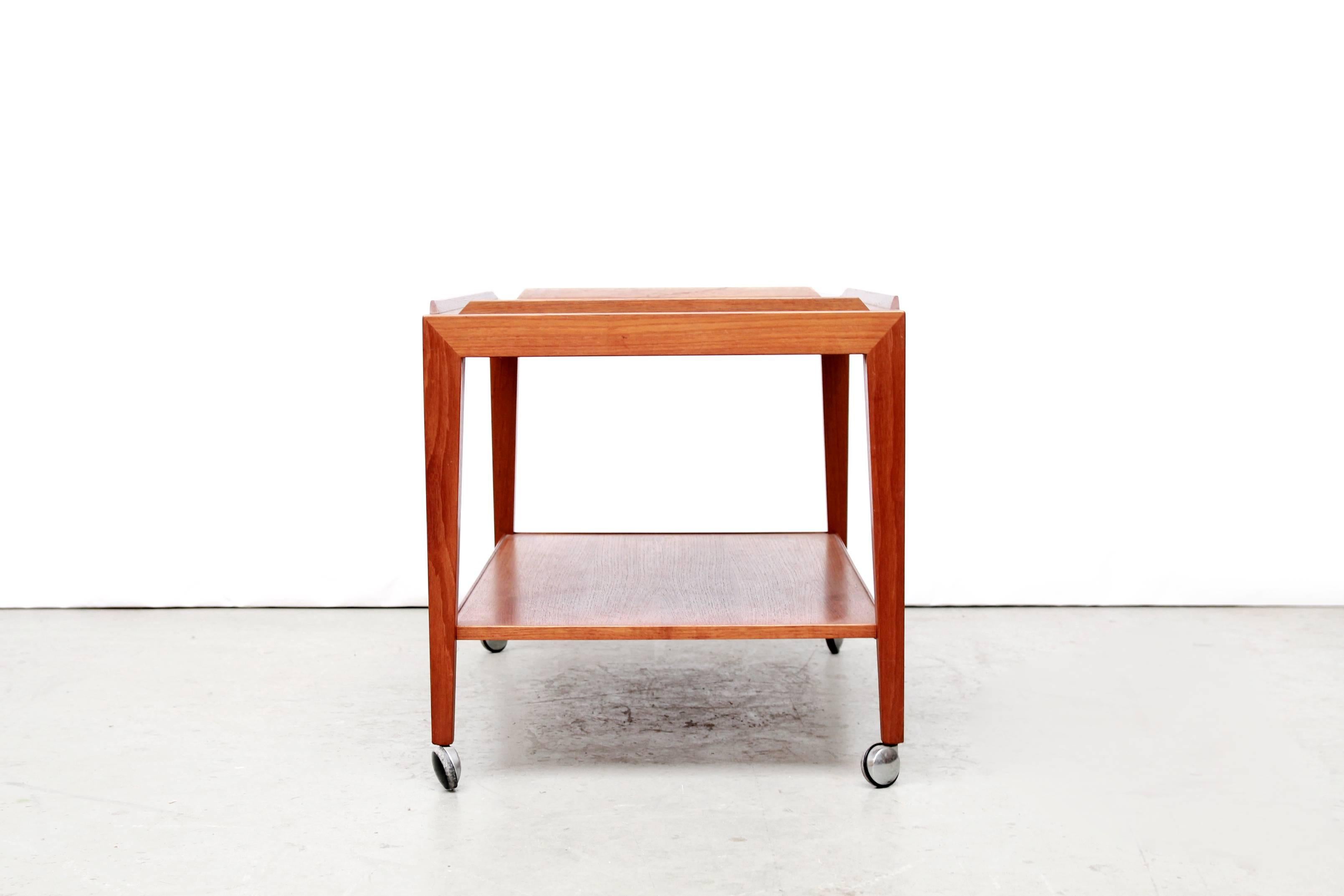 Beautiful tea trolley on wheels designed by Severin Hansen Jr. for Haslev Mobelfabrik and sold in the Netherlands by Bovenkamp. This table has the beautiful geometric connection of the legs to the tabletop what we are used to of Mr Severin