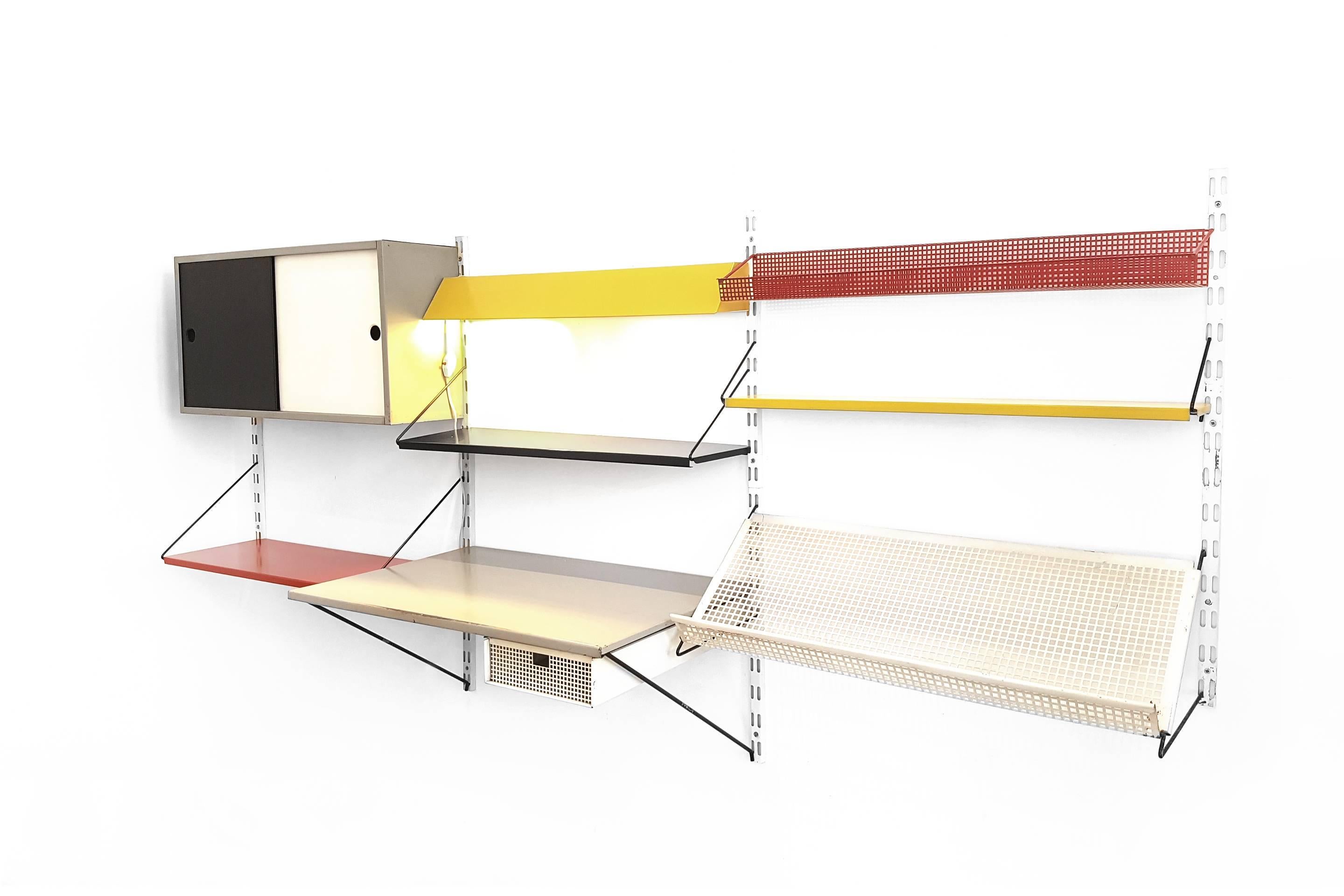 Beautiful Industrial Dutch wall system from the 1950s design by Tjerk Reijenga for the Dutch manufacturer Pilastro.
Very nice piece of Dutch modernist design. This metal wall rack consists of five white metal stands, five shelves in red, yellow