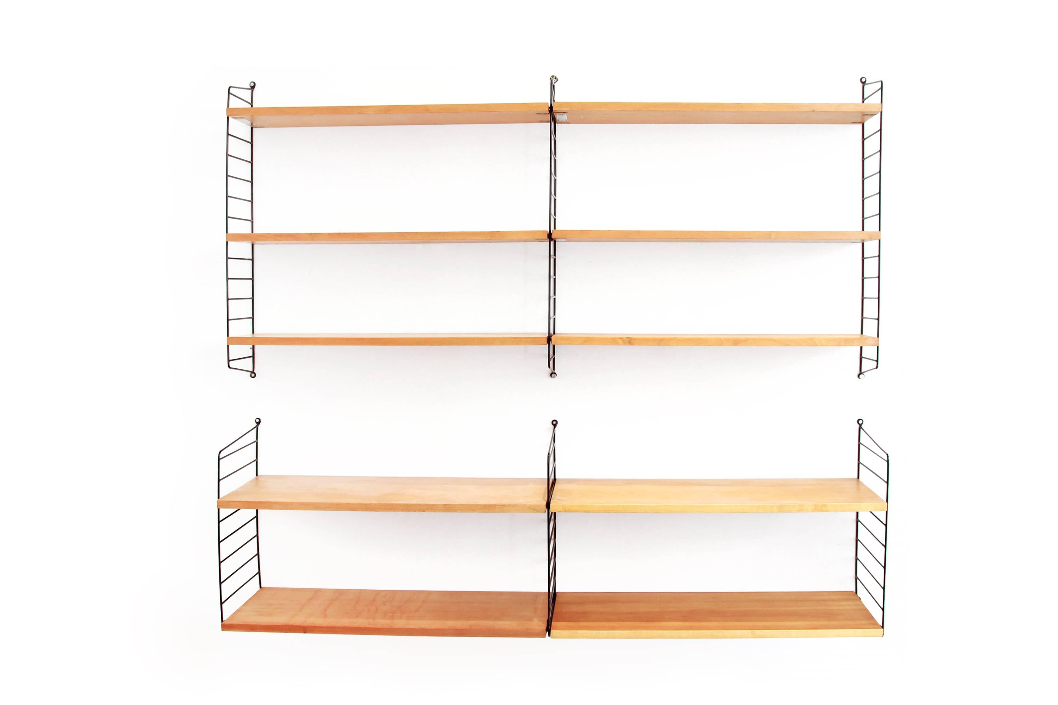 Beautiful string wall unit designed by Nils Nisse Strinning. The shelves are made of pine veneer and are 78 cm wide. This set consists of three normal sized black ladders and three deep ladders, six shelves of 20 cm deep and four shelves of 30 cm