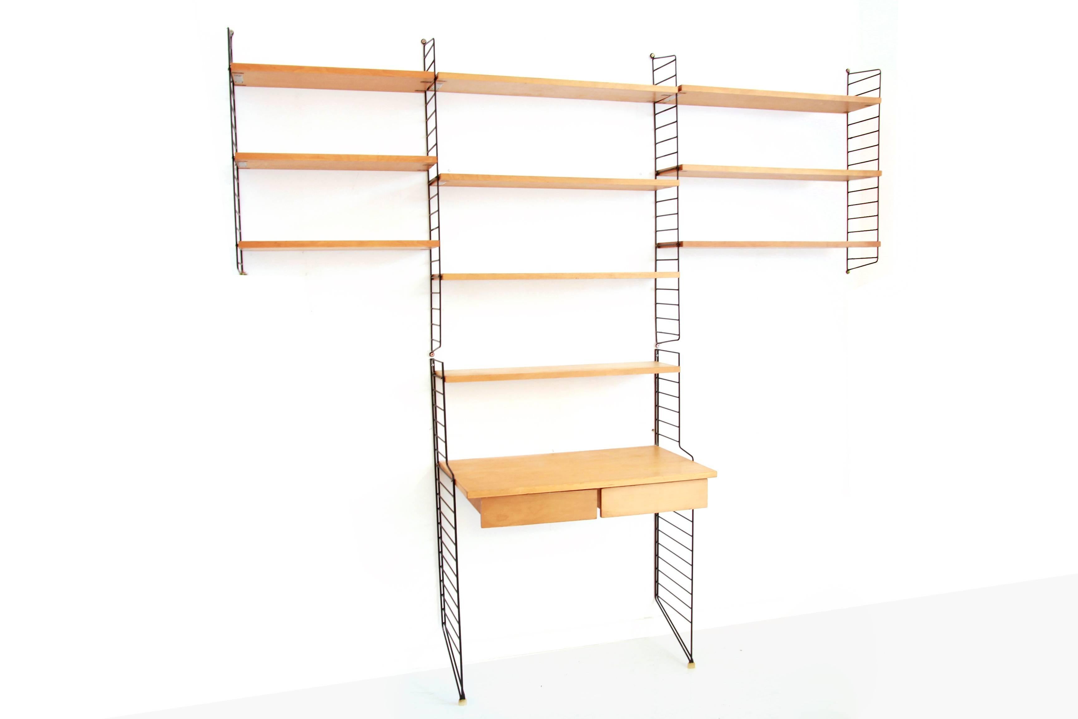 Beautiful string design wall system from Nisse Strinning in pine. Bokhyllan ’the ladder shelf’.
This set consists of four black ladders that can be hung on the wall and two black ladders that support on the floor, seven shelves of 78 cm wide and