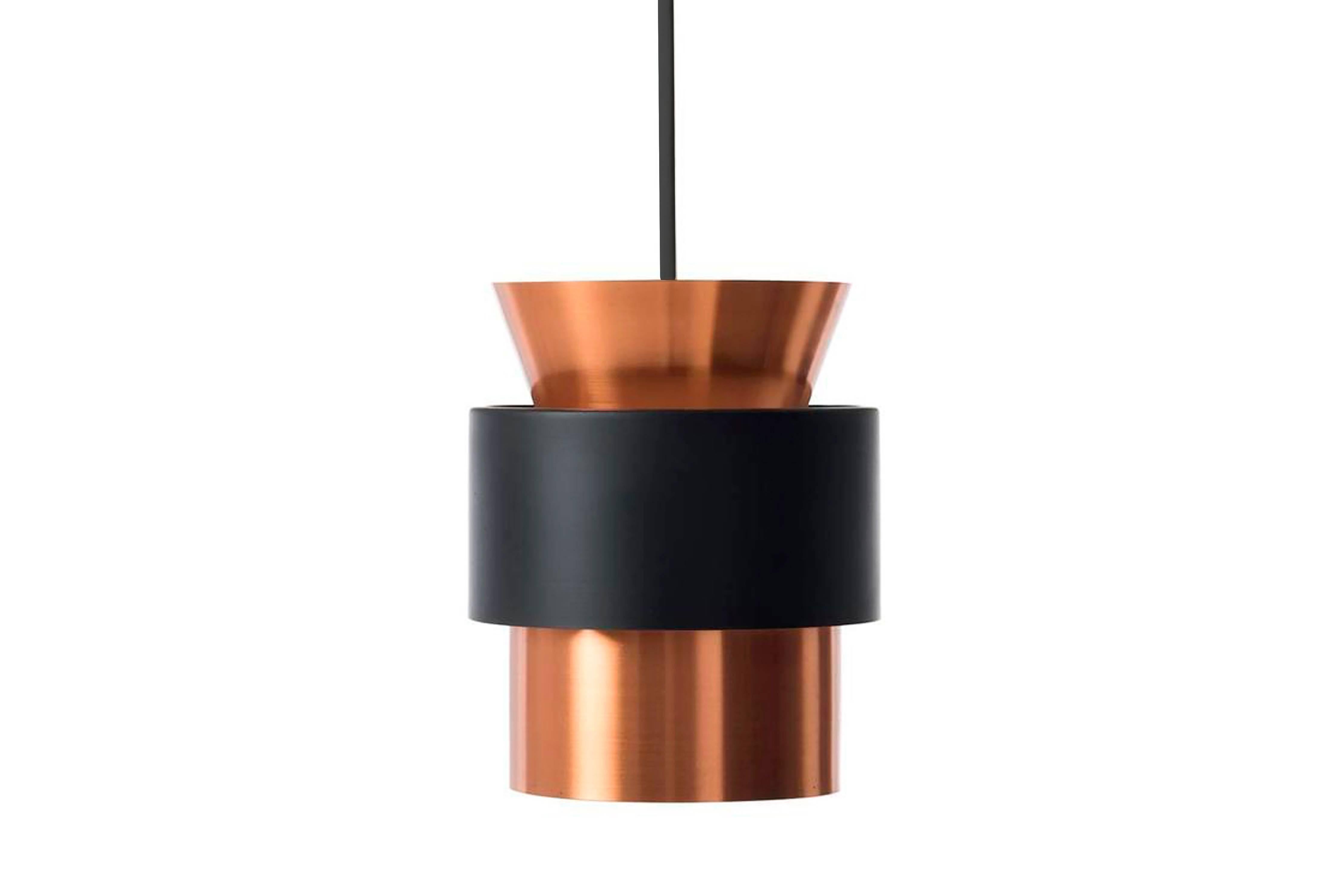 This is a solid copper lamp with black lacquered ring produced by Fog and Mørup in Denmark in the 1960s. We have three pieces available. All with new black fabric cable.