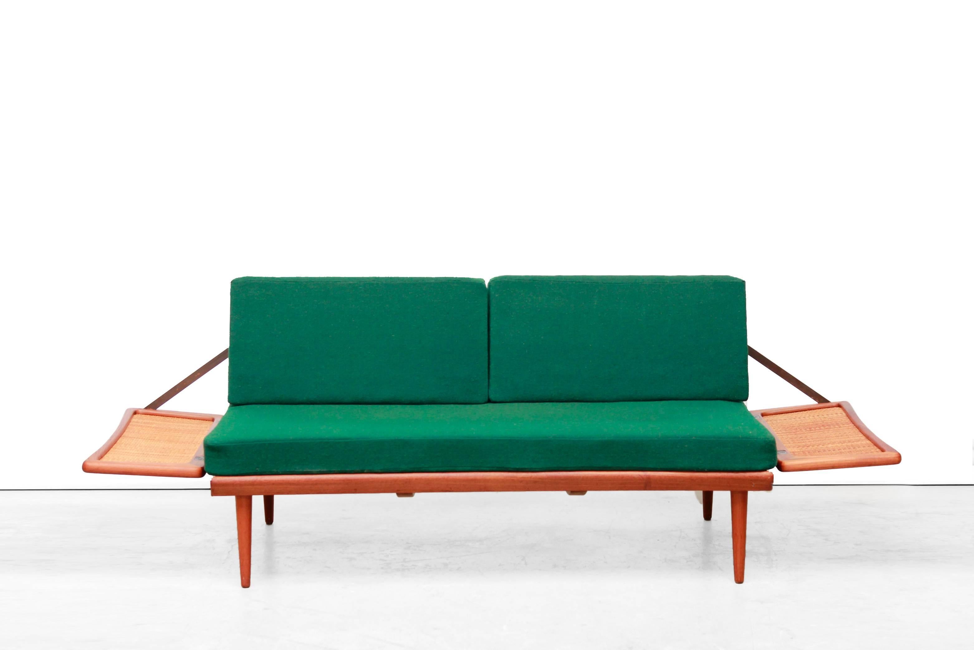 Particularly beautiful and rare sofa bed by Peter Hvidt and Orla Mølgaard Nielsen. 
This daybed with modelnam FD 451 os produced by France & Daverkosen in Denmark. The frame is made of solid teak wood and is of very high quality, with woven cane