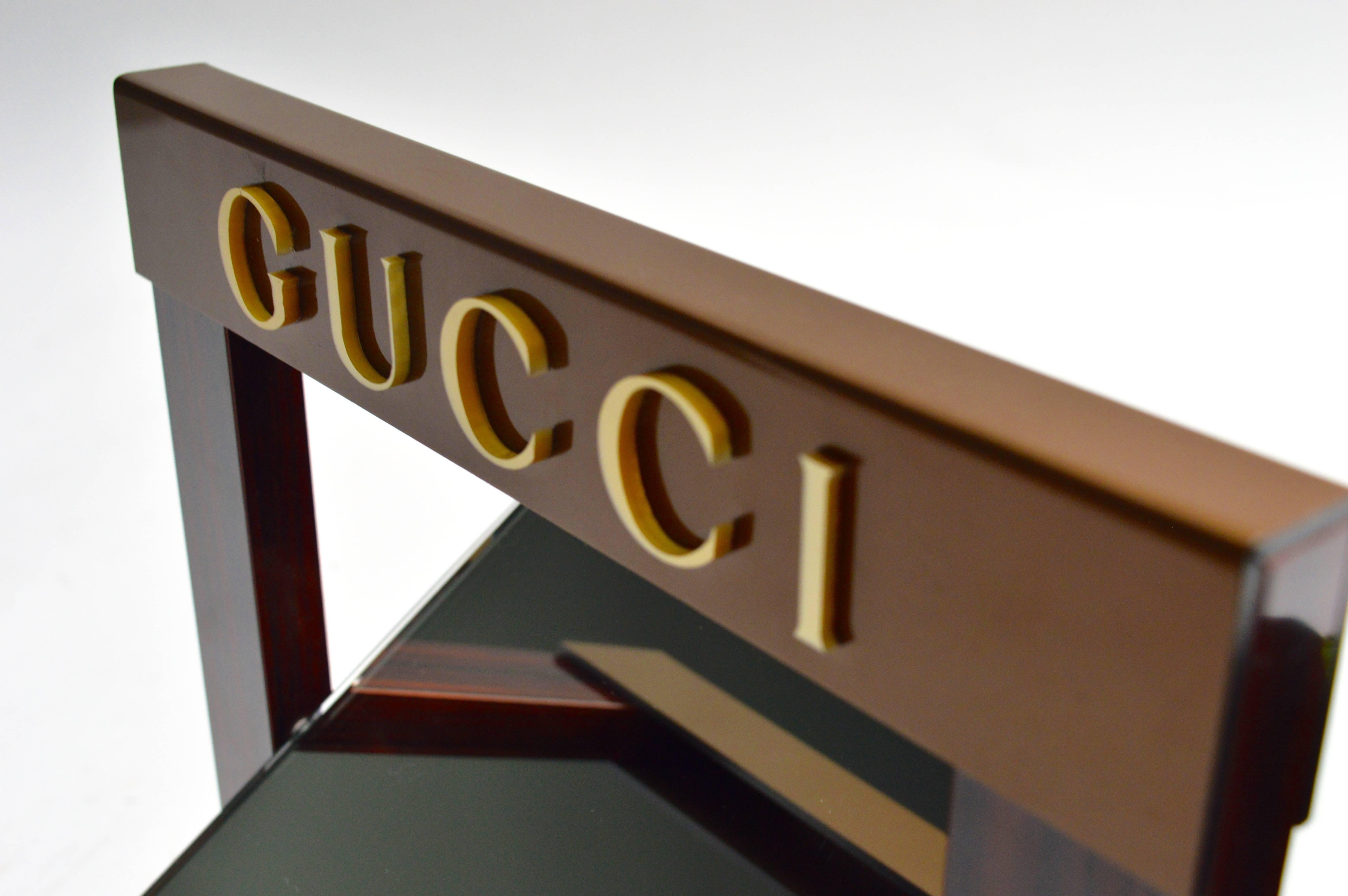 Vintage Gucci dealer mirror. Most likely used by Gucci as a store display. Front of glass is in perfect condition. Backing has a crack and has been glued. Slight cracking to one of the letters on the front. Very unique piece in very good vintage