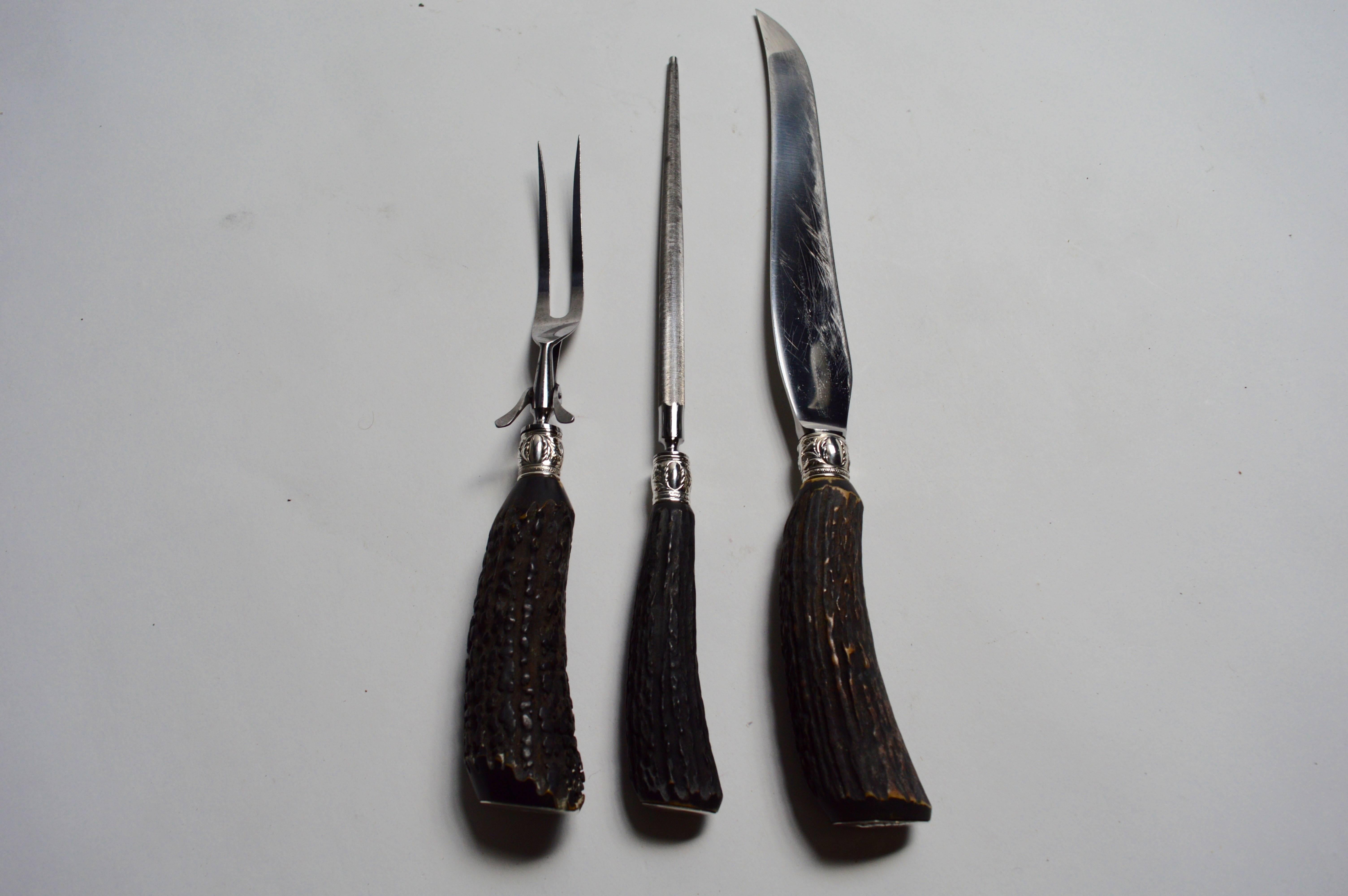 Rustic German cutler set with horn handles and steel hardware. Sterling silver tabs at the end of each handle and on the underside of each piece. Set includes blade, blade sharpener and fork. Unique set. Excellent vintage condition.