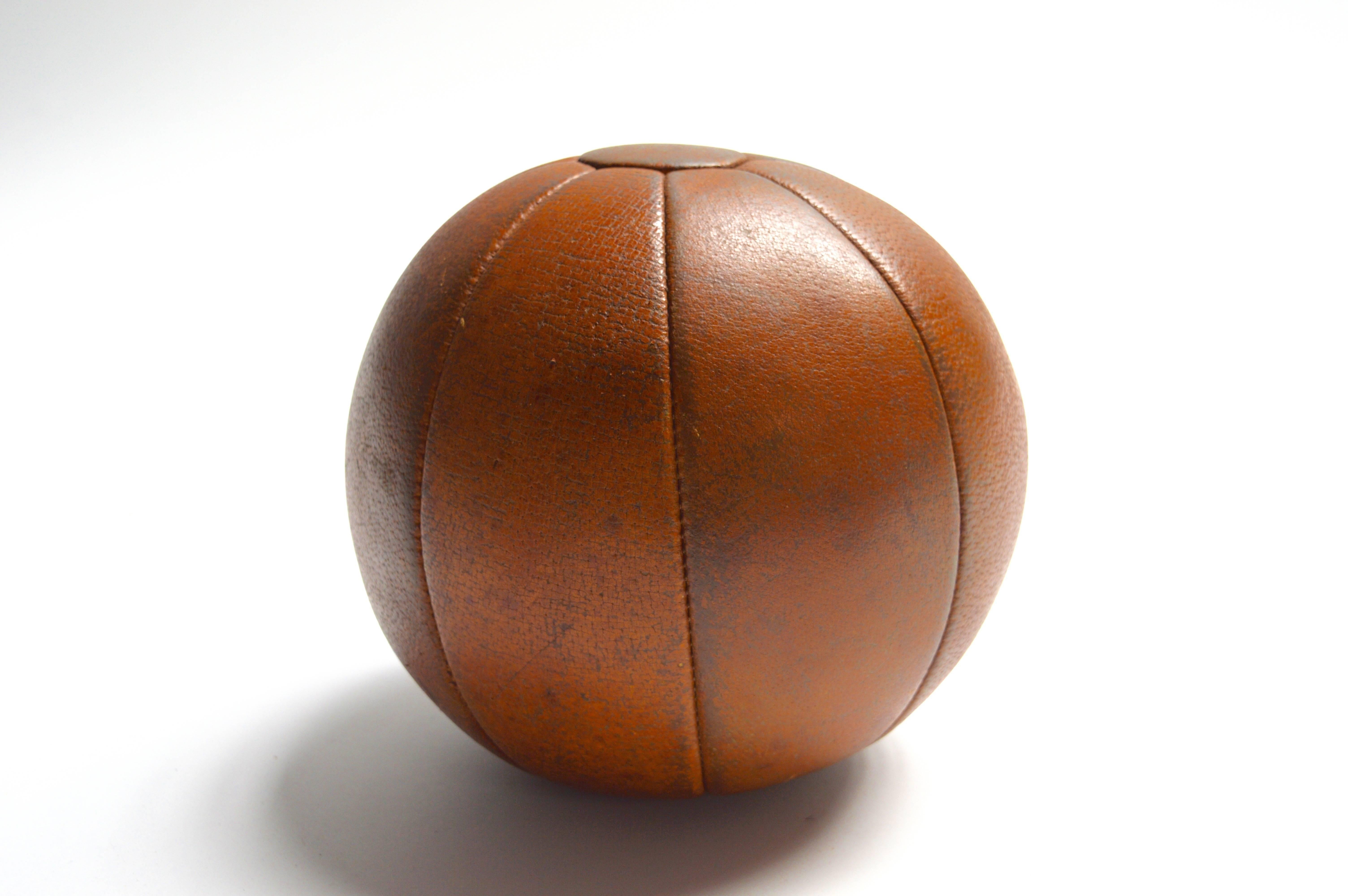 Handsome French medicine ball. Great patina to saddle leather. Excellent vintage condition. Great tabletop object. Perfect accessory for a home gym.