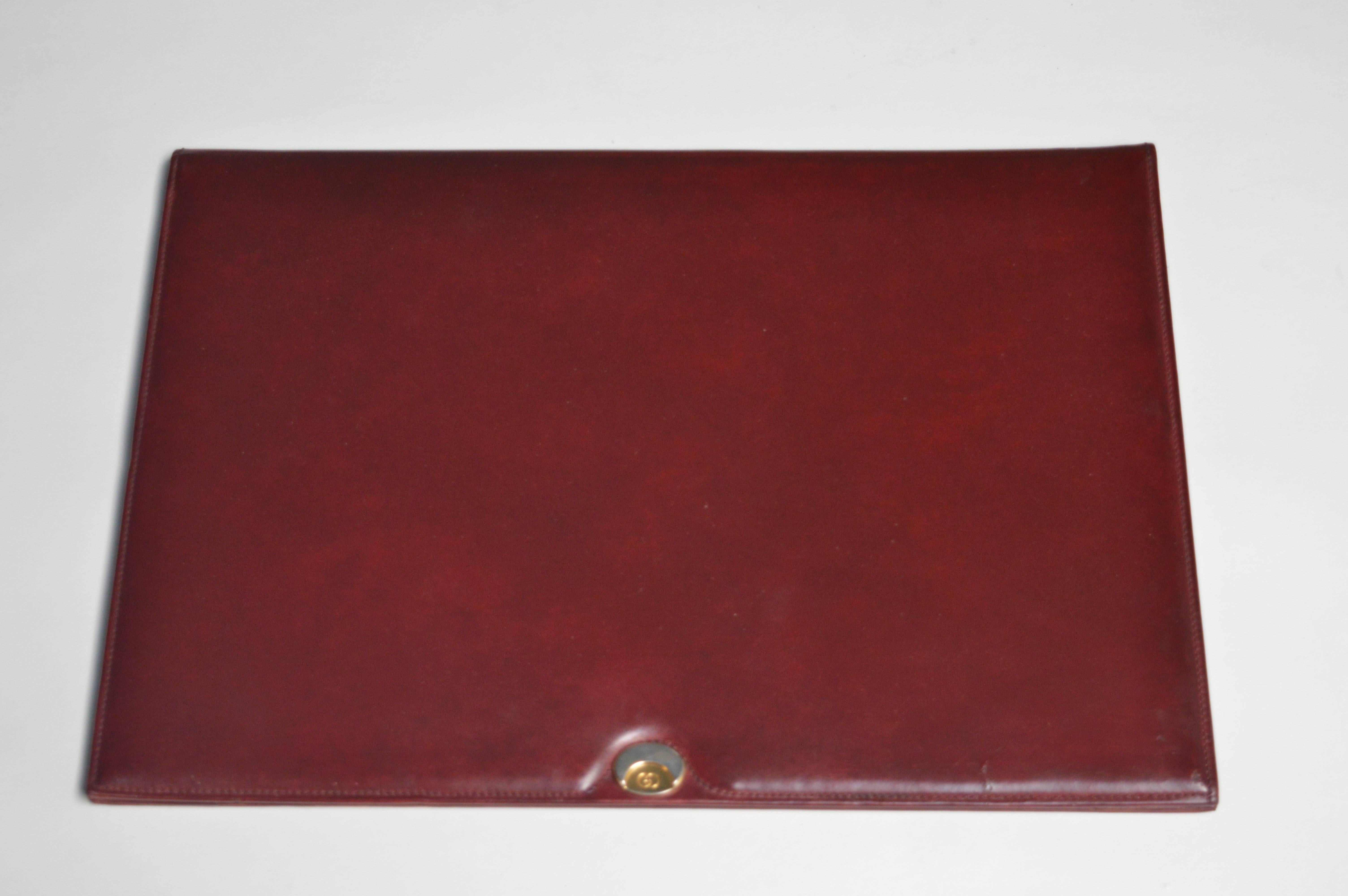 Handsome red leather Gucci desk calendar and writing pad. Original paper inside. Brass and chrome Gucci badge on front and Gucci logo stamped underneath. Excellent vintage condition.