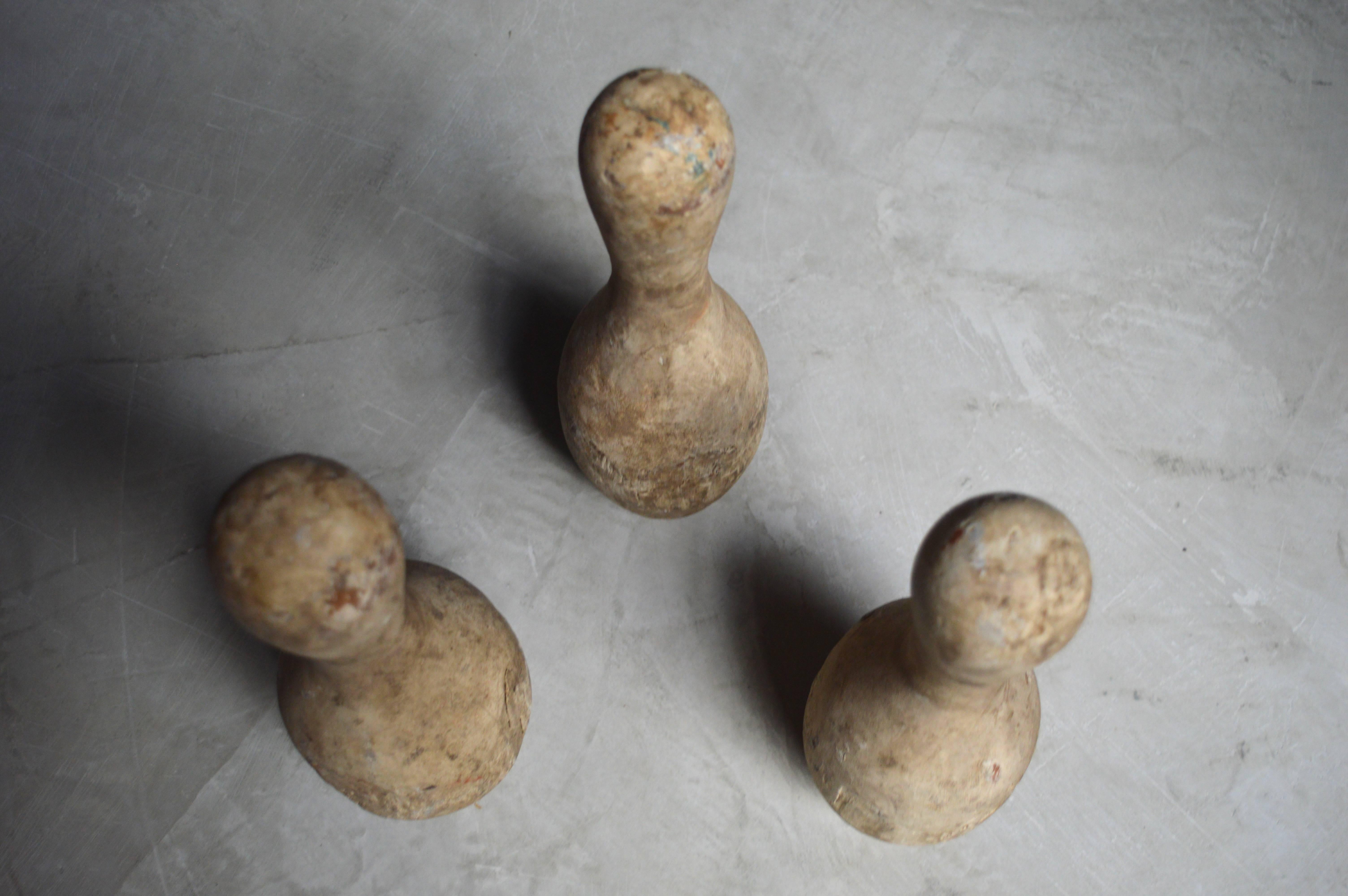 Unique set of three wood bowling pins. Great age and coloring to the wood. Sold as a set of three. Good vintage condition.