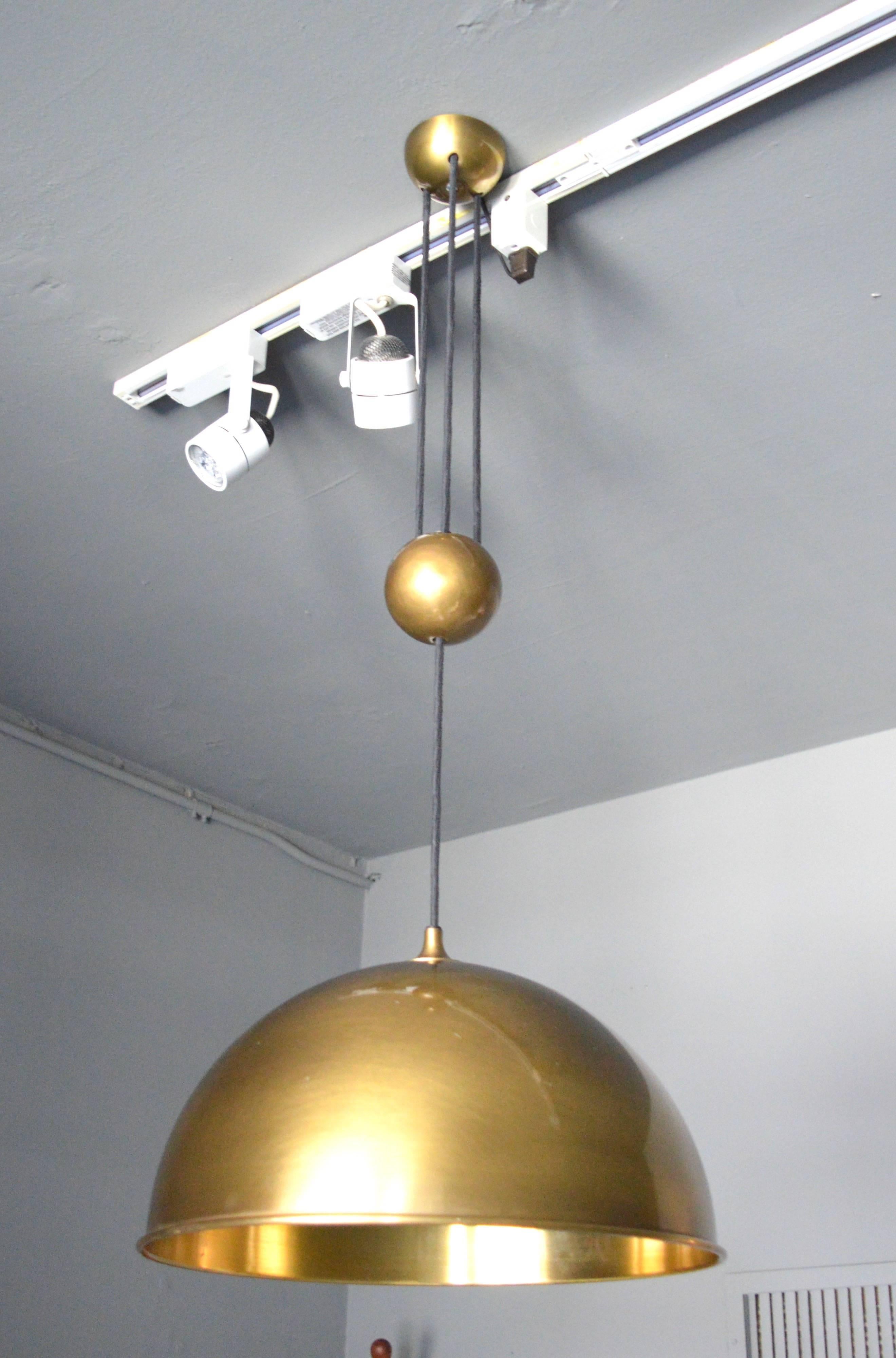 Fantastic vintage brass dome counter balance pendant by Florian Schulz. Brass dome canopy, brass ball counter-weight and brass dome. Cloth cord. Excellent patina to brass. Excellent vintage condition. Overall height is adjustable from 24