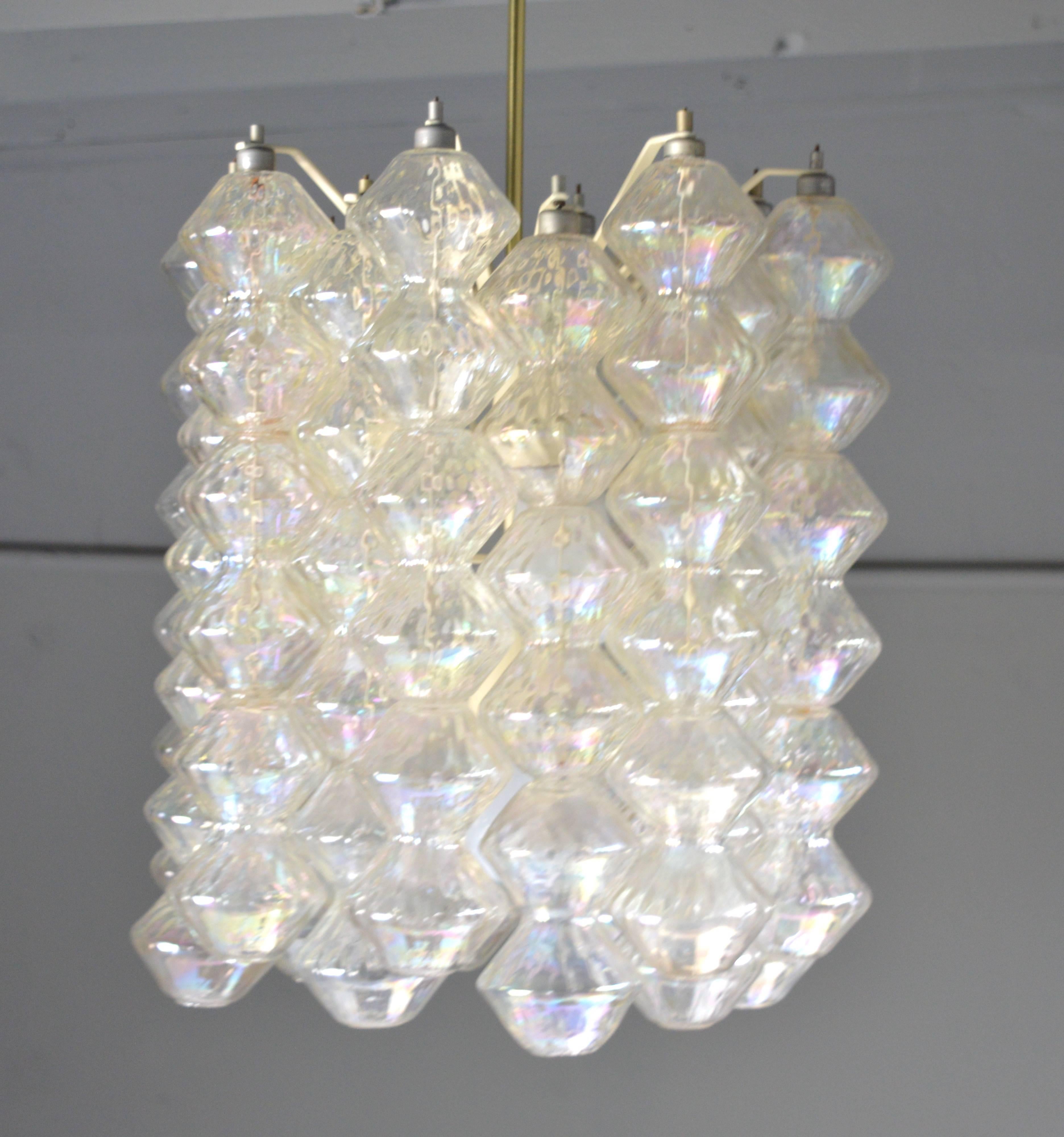 Stunning glass chandelier by Venini. 19 rows of translucent glass with 108 polyhedral shaped pieces fused or placed together. Newly rewired. Illuminates beautifully and looks amazing with the light both off and on. Fantastic light fixture.