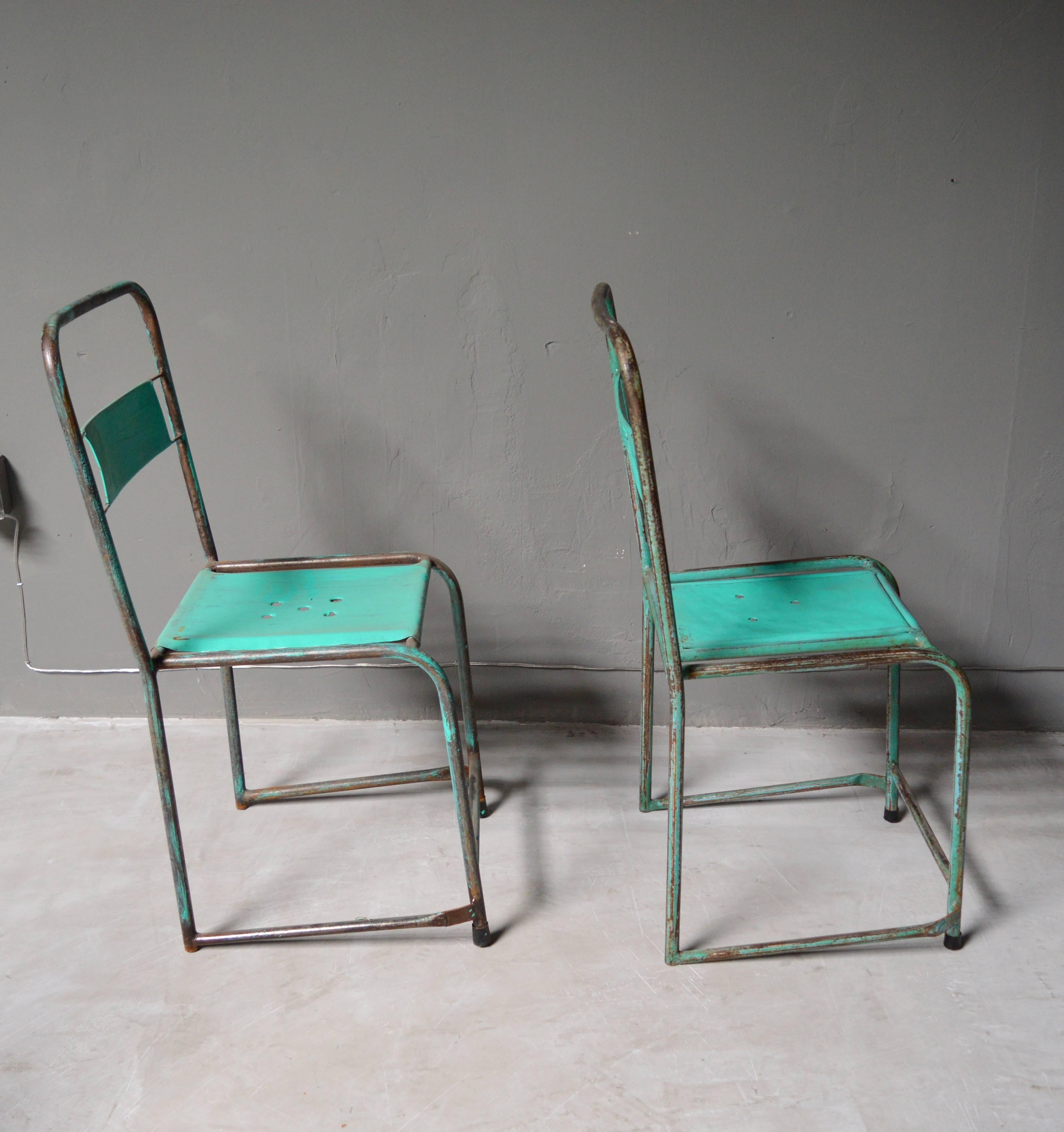 Great set of French metal school chairs. Great patina and age to metal. Each chair in its own state of vintage condition. Very unusual frame. Surprisingly comfortable. Perfect indoors or out. Sold as a set of four. A set of four yellow school chairs