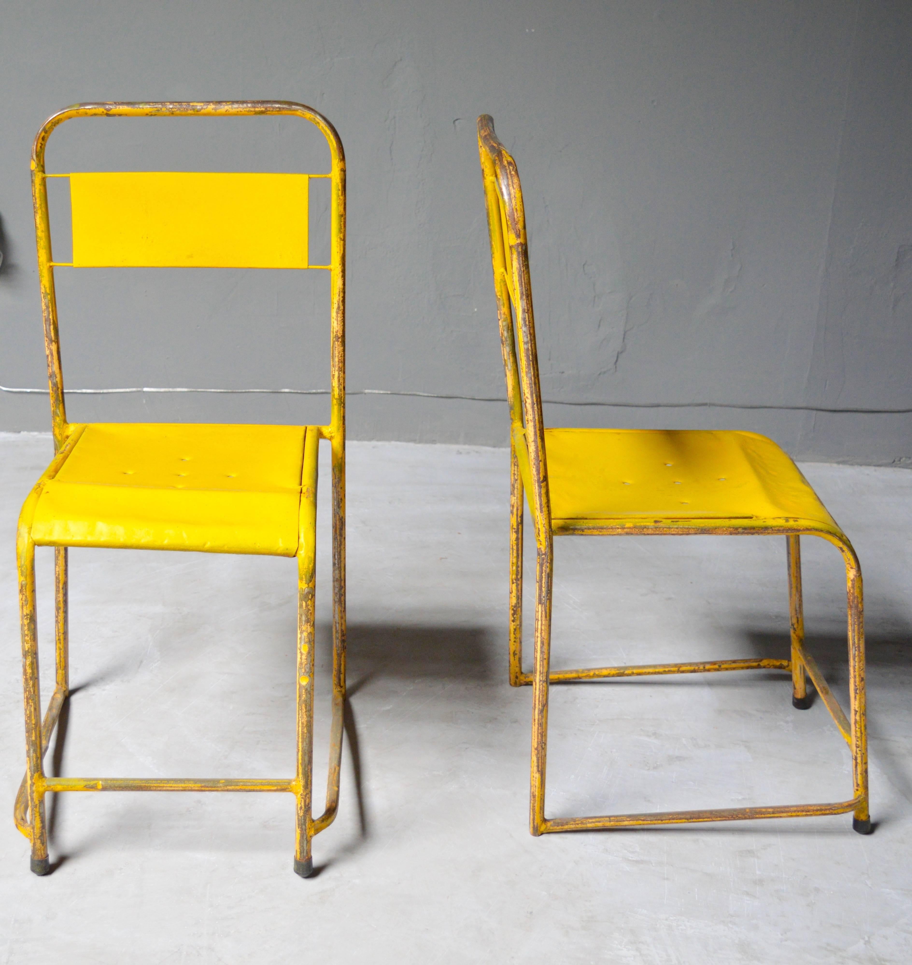 Great pair of French metal school chairs. Great patina and age to metal. Each chair in its own state of vintage condition. Very unusual frame. Surprisingly comfortable. Sold as a pair. 

A set of four turquoise school chairs also available in a