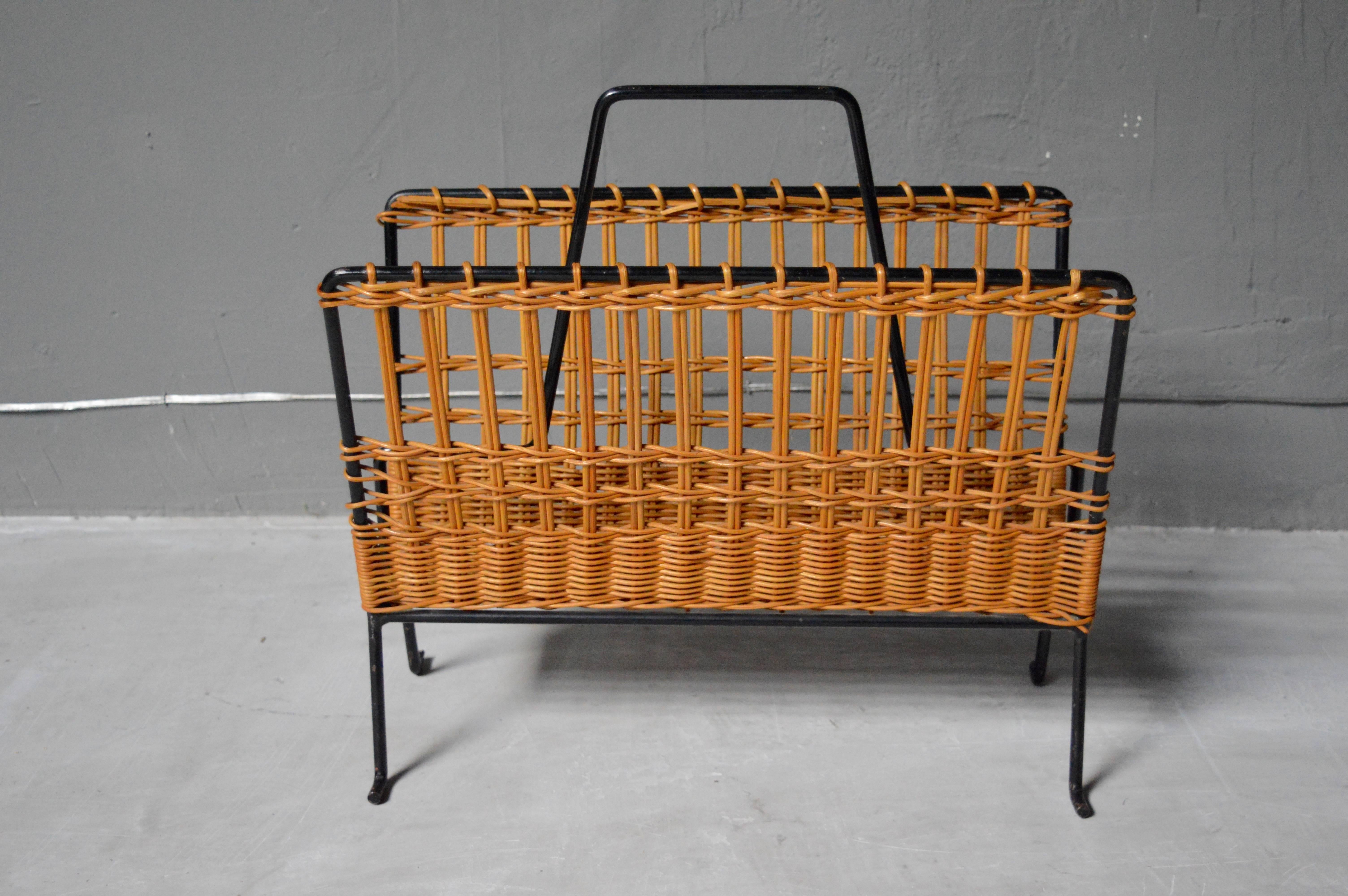 Handsome French magazine rack made of woven rattan with an iron frame. Very sturdy. Excellent vintage condition.