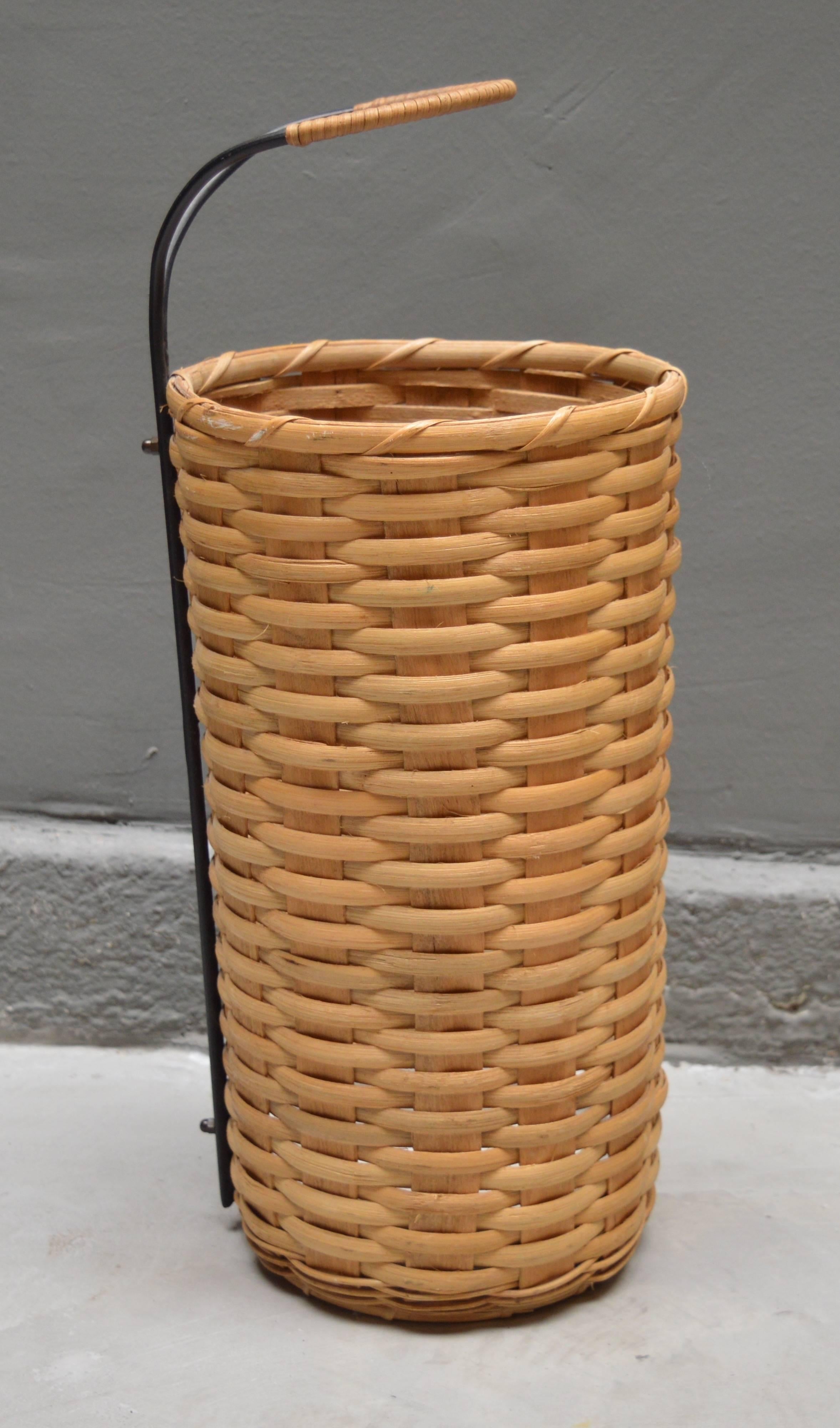 German umbrella stand made of rattan and iron. White ceramic dish inside to catch water. Excellent vintage condition.