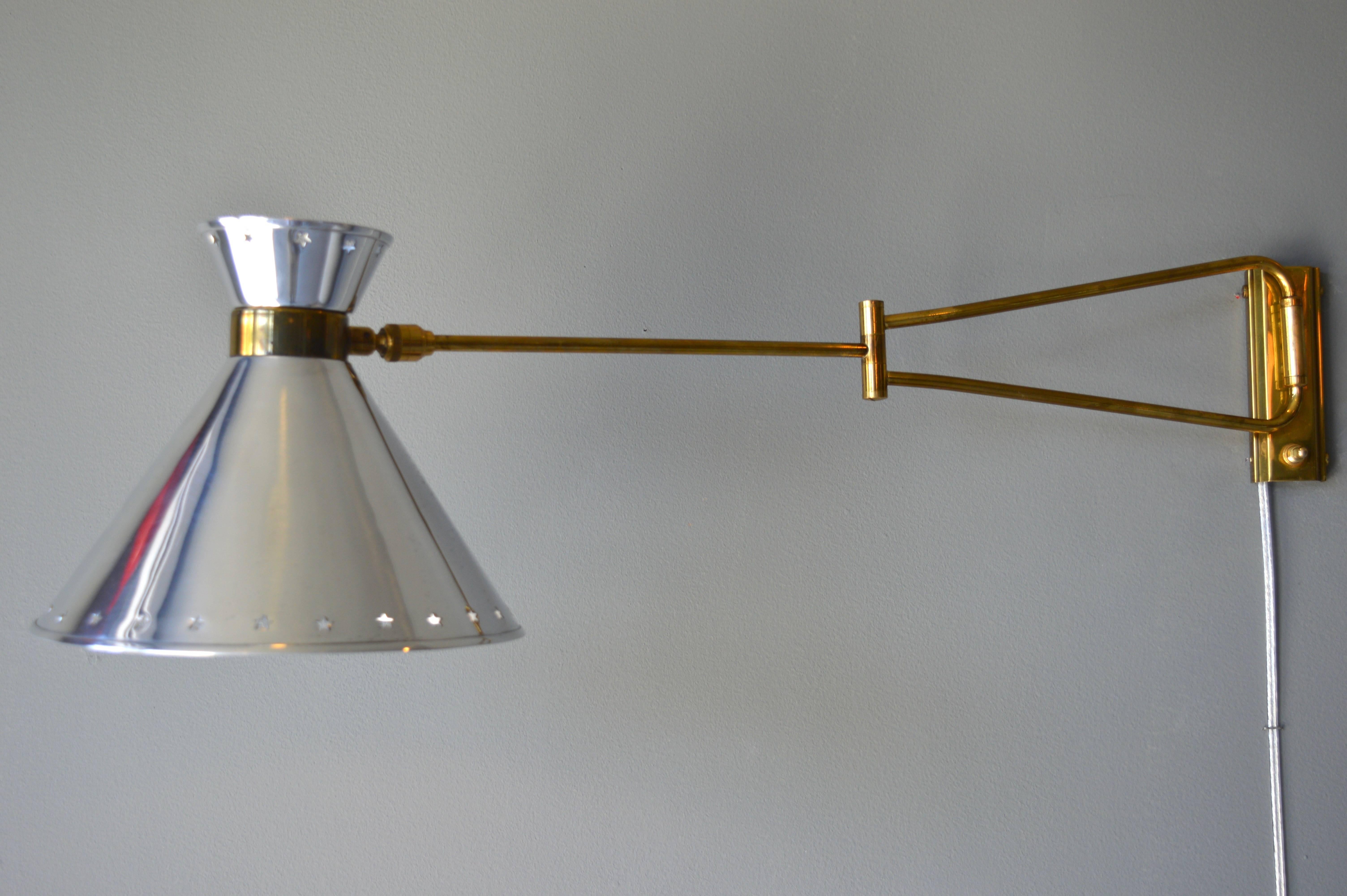 Fantastic articulating sconce by Lunel. Polished aluminum shade with brass backplate, arms and hardware. Newly rewired. Excellent vintage condition.