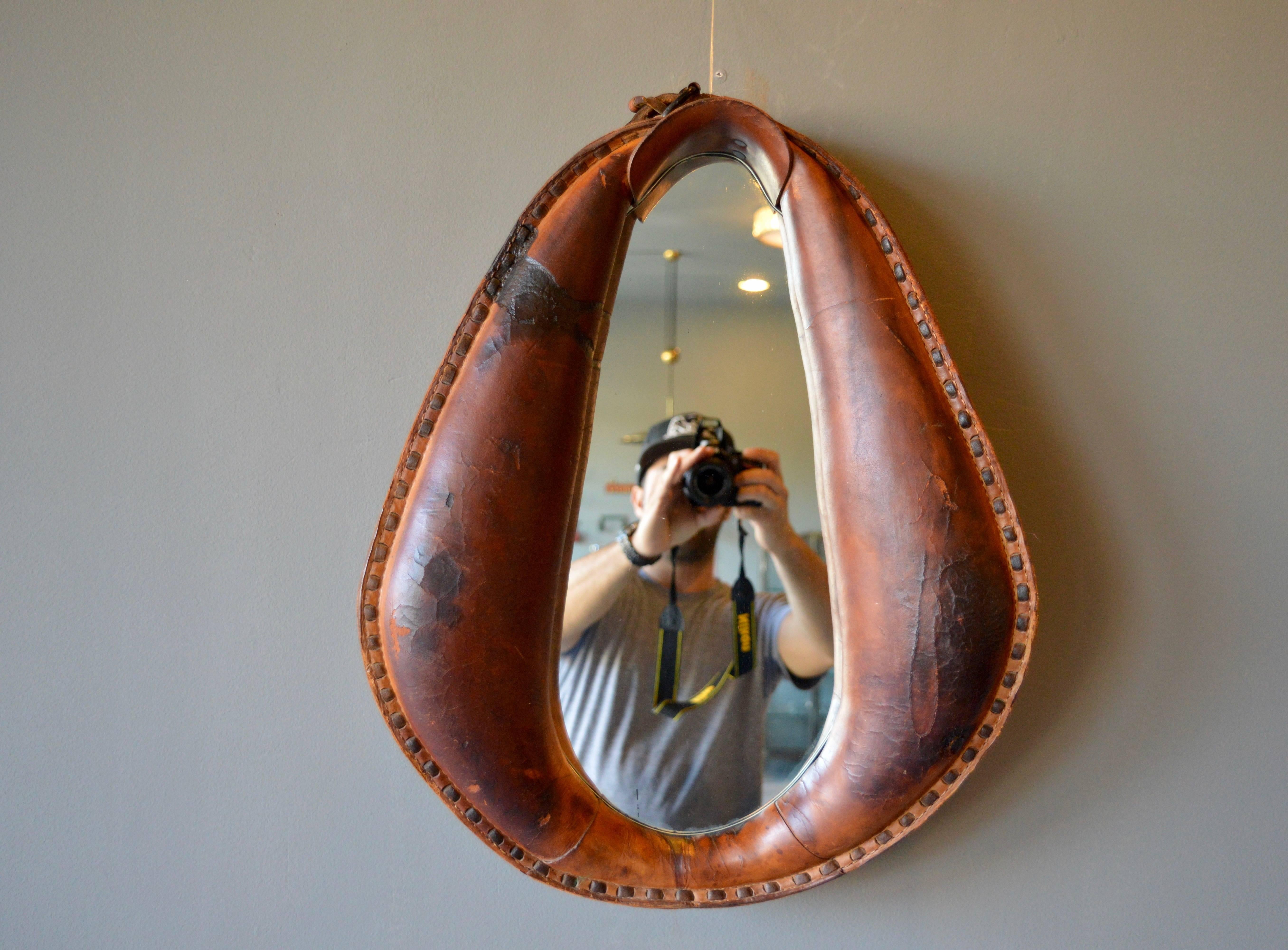 Rustic leather horse harness with custom inset mirror. Great patina to leather. Unique piece of wall-art and mirror. Excellent vintage condition.