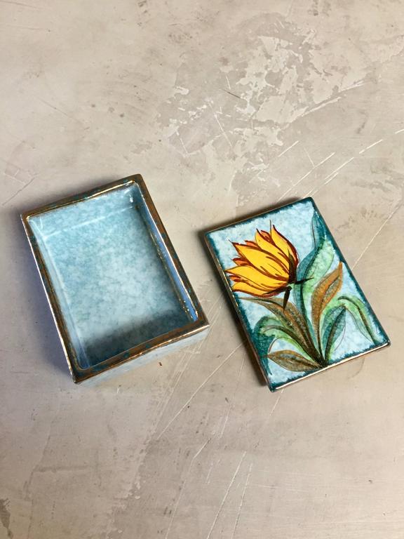 Beautiful ceramic box made in Italy by Raymor. Blue tones with green leaves and yellow lotus flower. Great stash box or jewelry box. Excellent vintage condition.