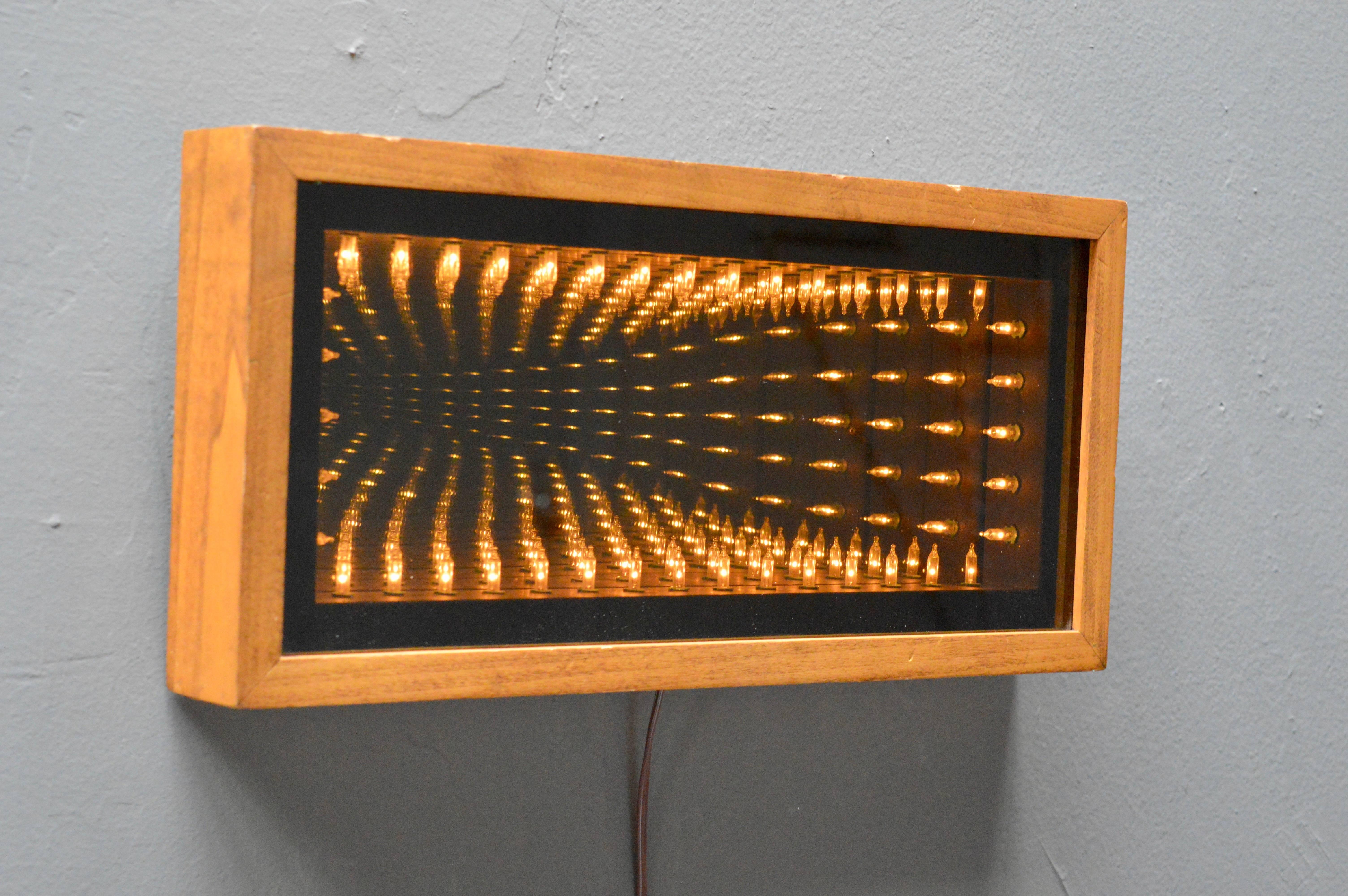 Excellent vintage infinity mirror. Mirror is fully functional with on and off switch. All bulbs working. Great vintage condition. Can be hung vertically or horizontal. Fantastic piece of wall art.