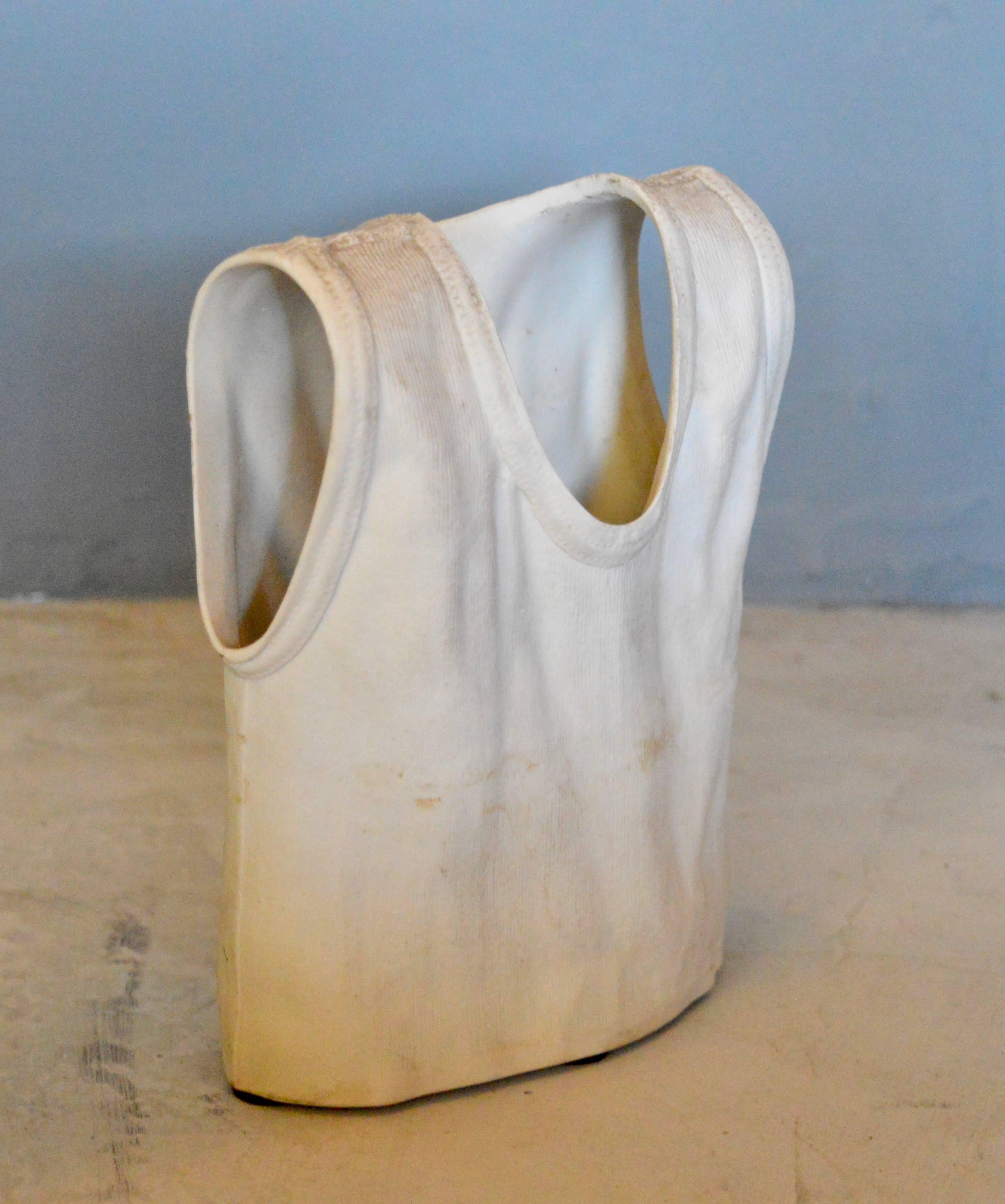 Unique white ceramic t-shirt vase made in Canada. Very interesting sculptural object. Larger ceramic t-shirt vase available in separate listing. Matching t-shirt vase available in separate listing in light blue and in pick. Excellent vintage
