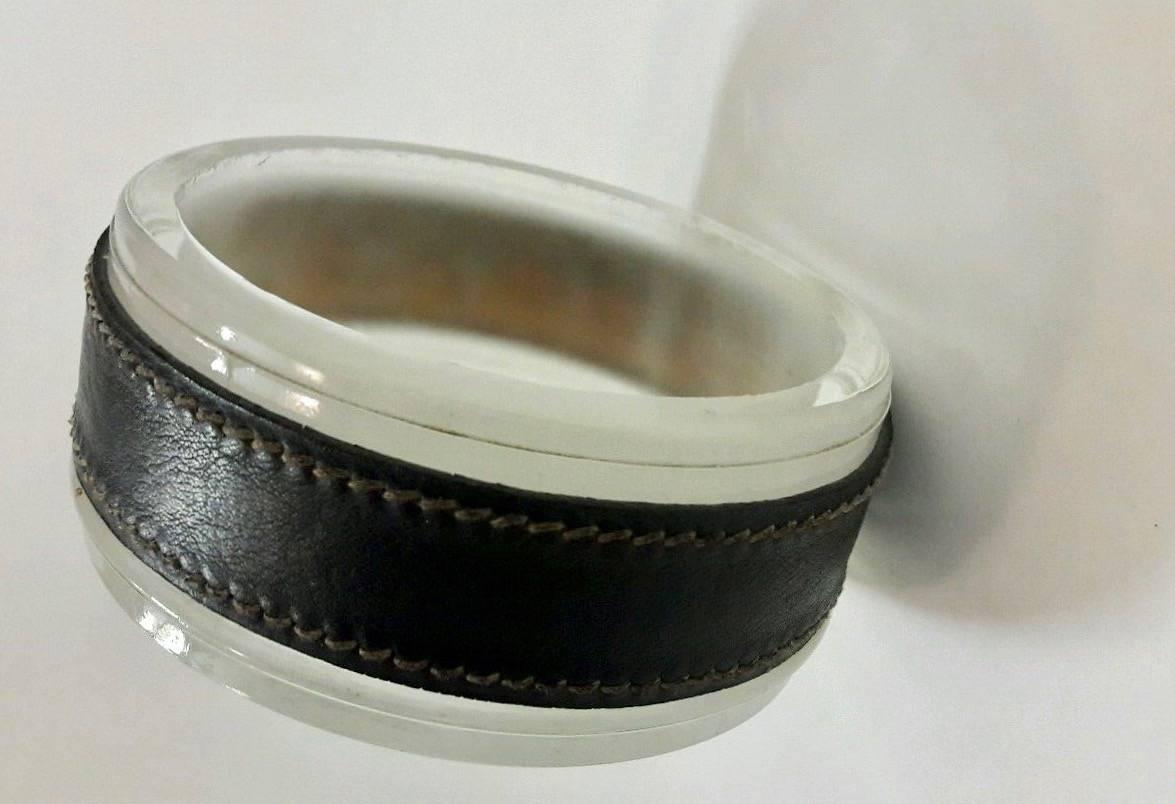 Handsome leather and glass ashtray or catchall by French designer Jacques Adnet. Signature Adnet contrast stitching throughout. Excellent patina to black leather. Great desktop piece or catchall to put by the front door. Excellent vintage condition.