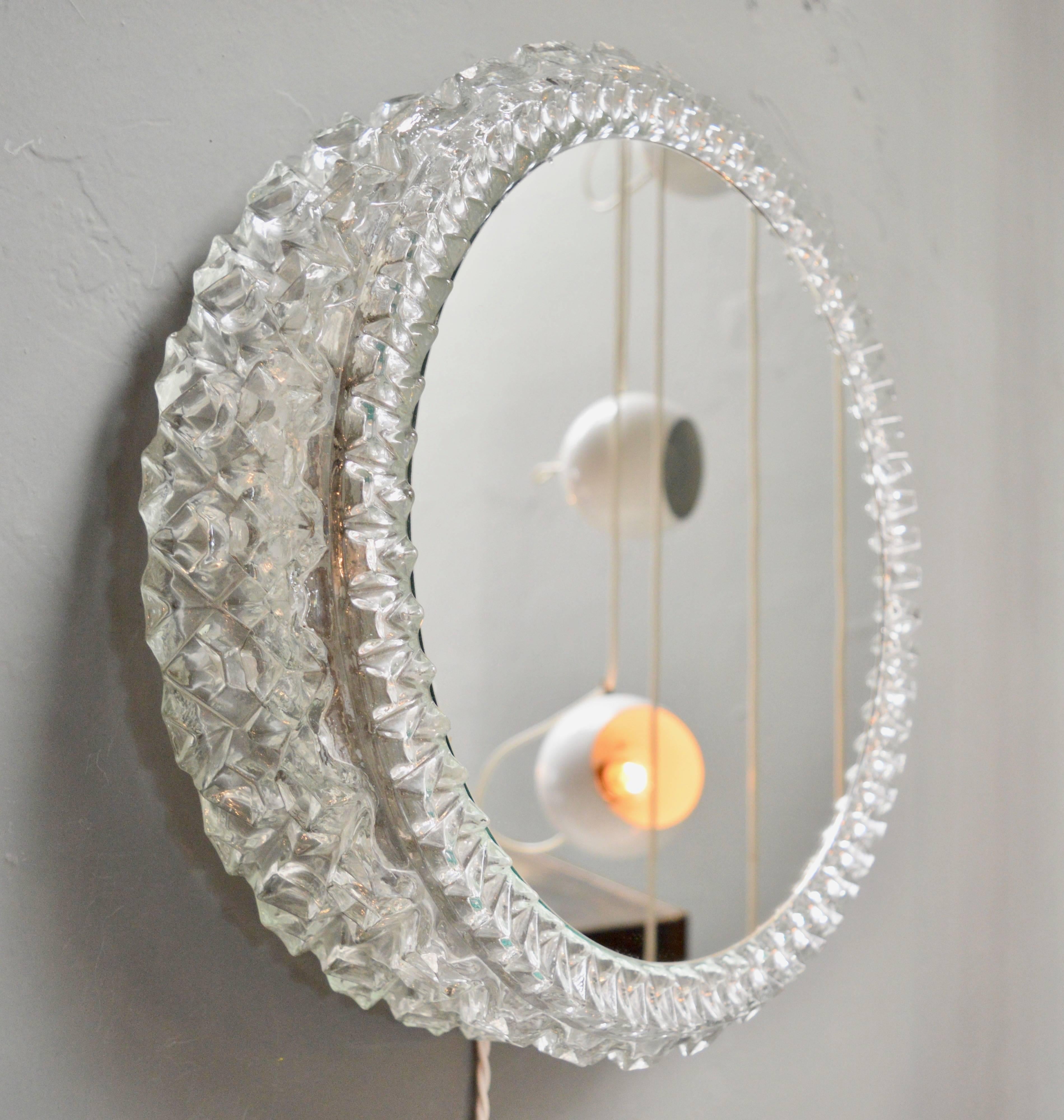 Elegant German glass mirror built in lights. Looks gorgeous on and off. Three 45 watts bulbs inside fixture. Newly rewired. Excellent vintage condition. Perfect vanity mirror or wall art!