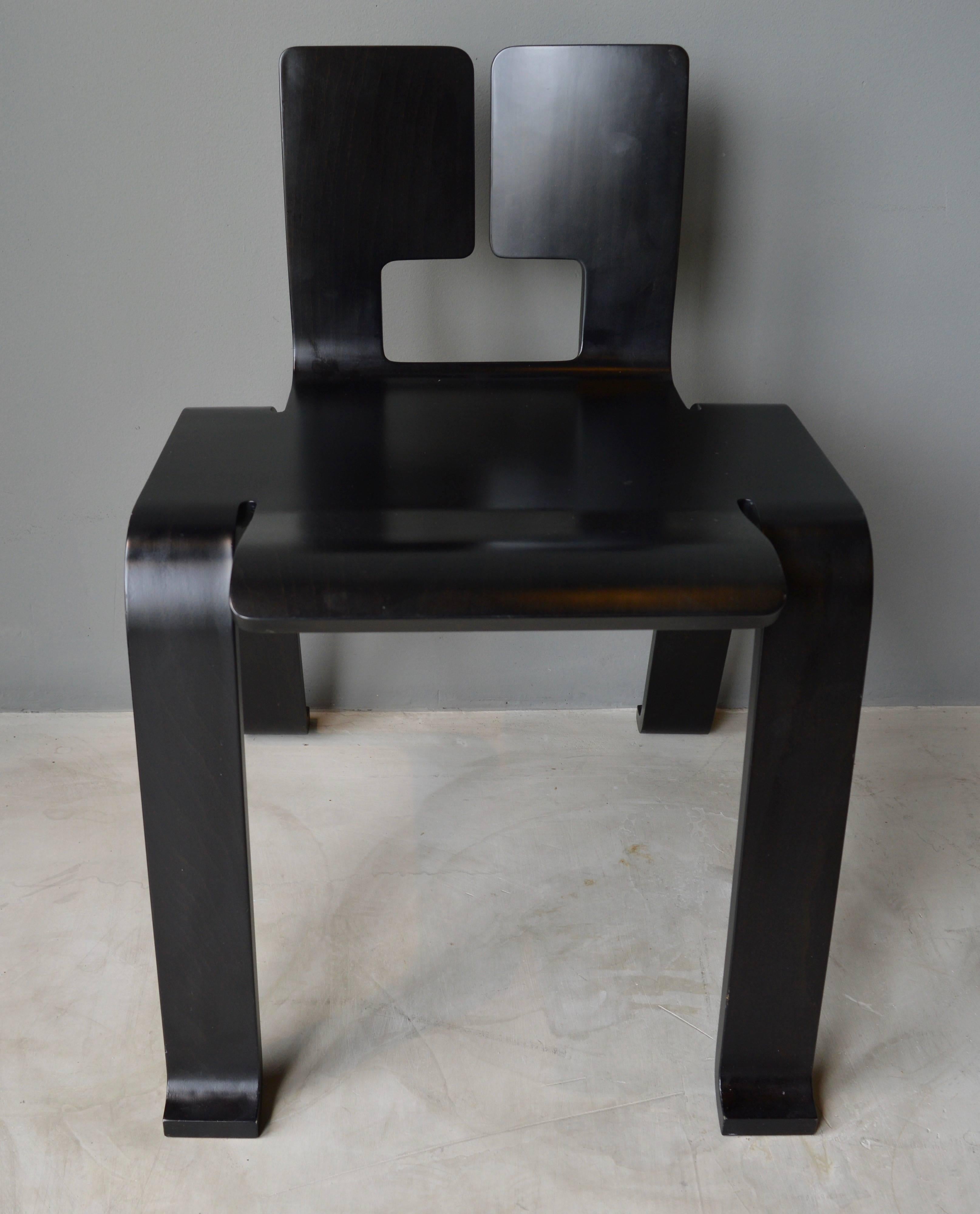 Artistic ebony wooden chair designed by Charlotte Perriand. Reproduced by Cassina. Unknown year on the chair. Lightweight chair with graceful folds, resembles origami and was created in Japan in 1954 for the Synthèse des Arts exhibition. Excellent