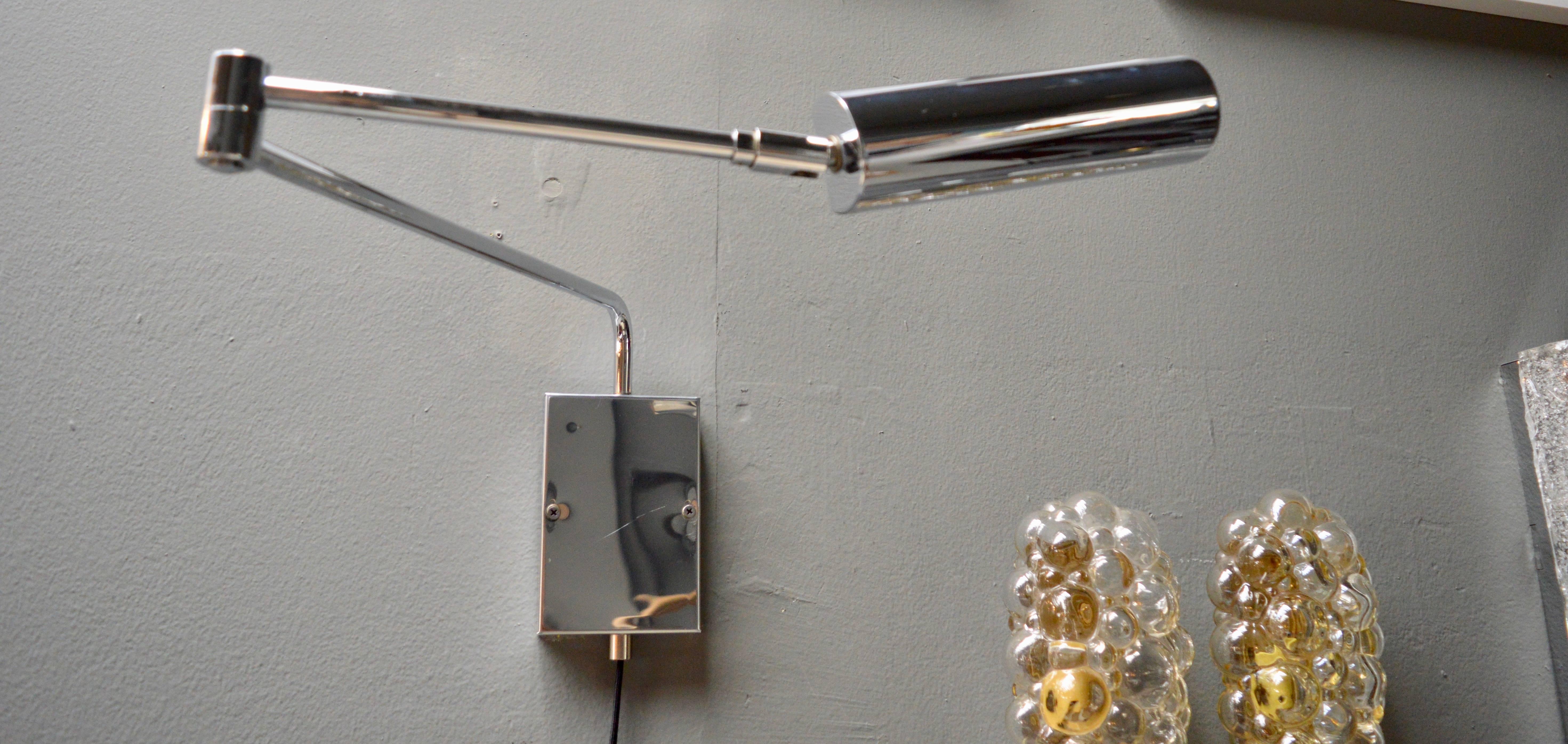 Fantastic wall sconce by Koch and Lowy. Chrome lamp with all chrome hardware and wall plate. Lamp articulates in all directions and has a swing arm that can sit flush, folded against the wall or extend three feet out. Perfect bedside, desk side or