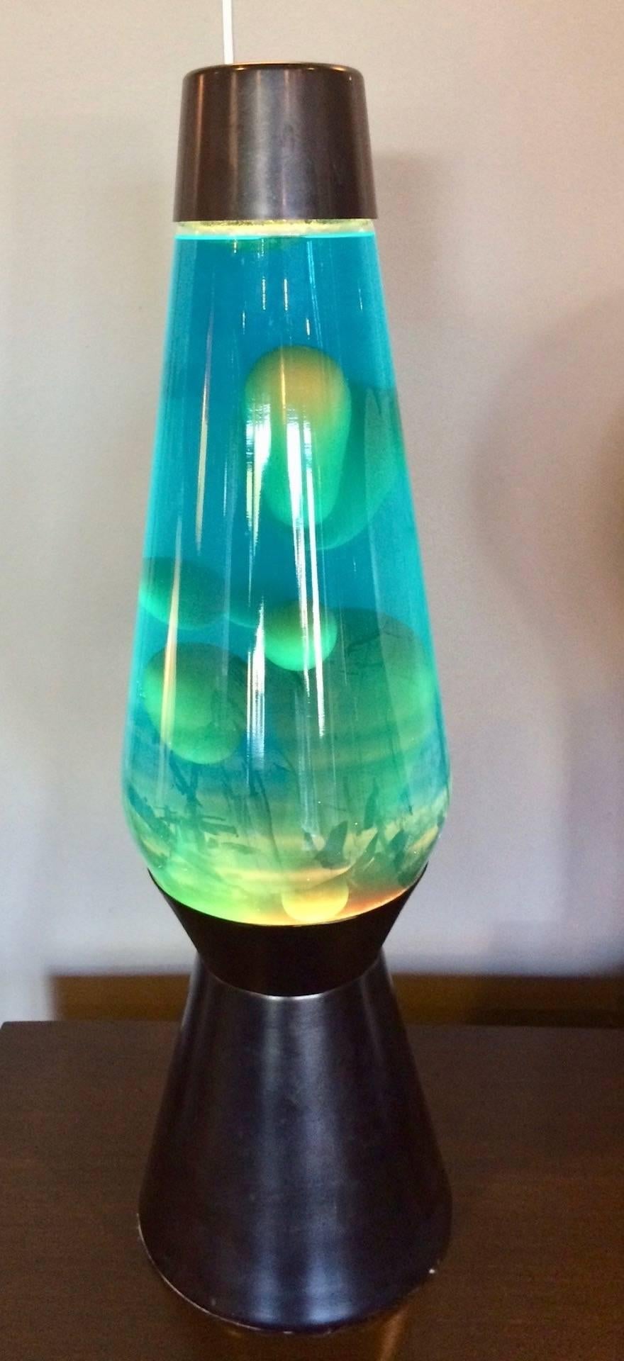Massive, oversized store display lava lamp. Black base with new bulb. Blue water with yellow 