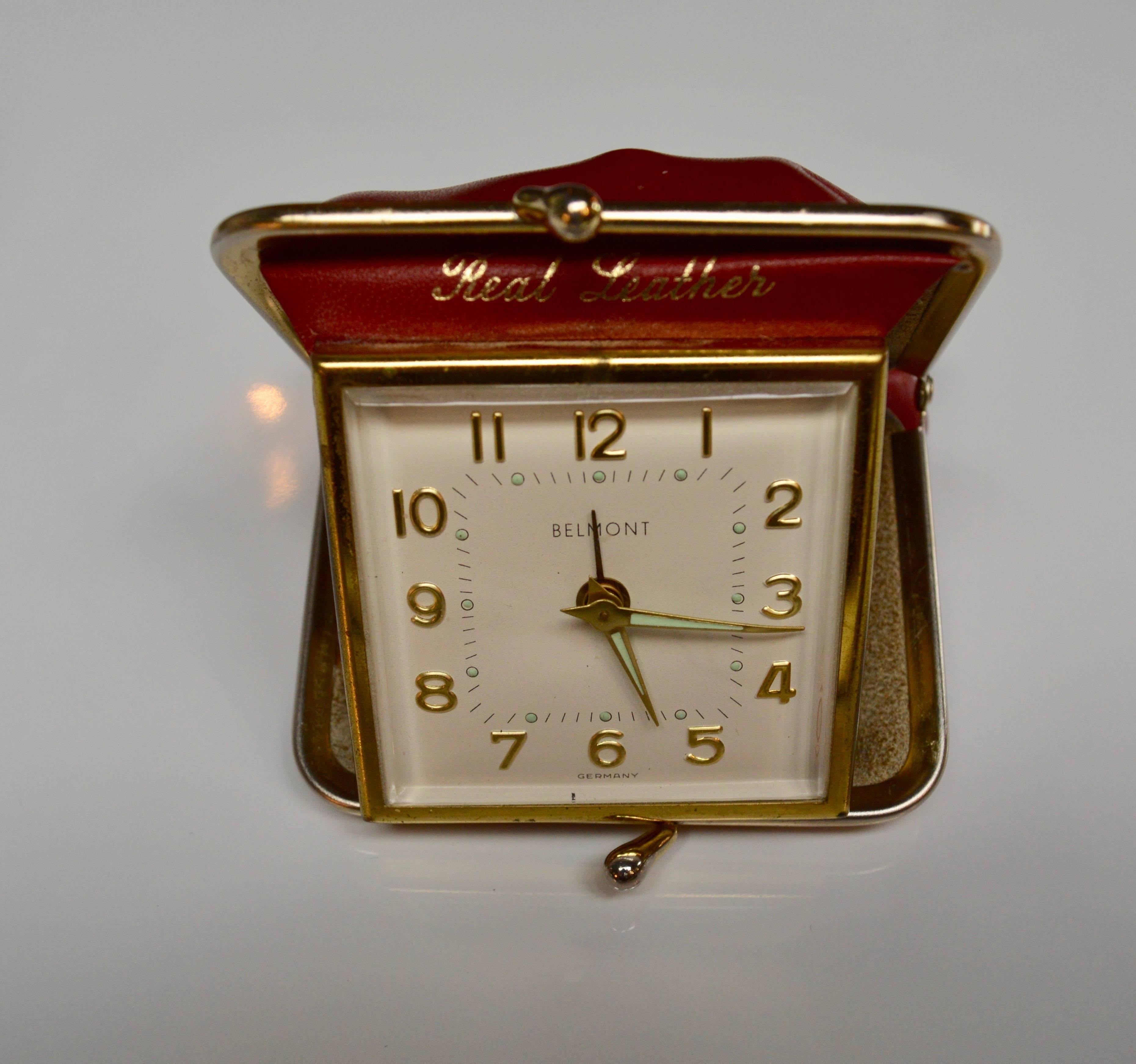 Miniature travel clocked enclosed in a change purse. Cute trinket/ gift. Looks like a change purse when closed. Brass clock folds open when purse is opened. Great condition.