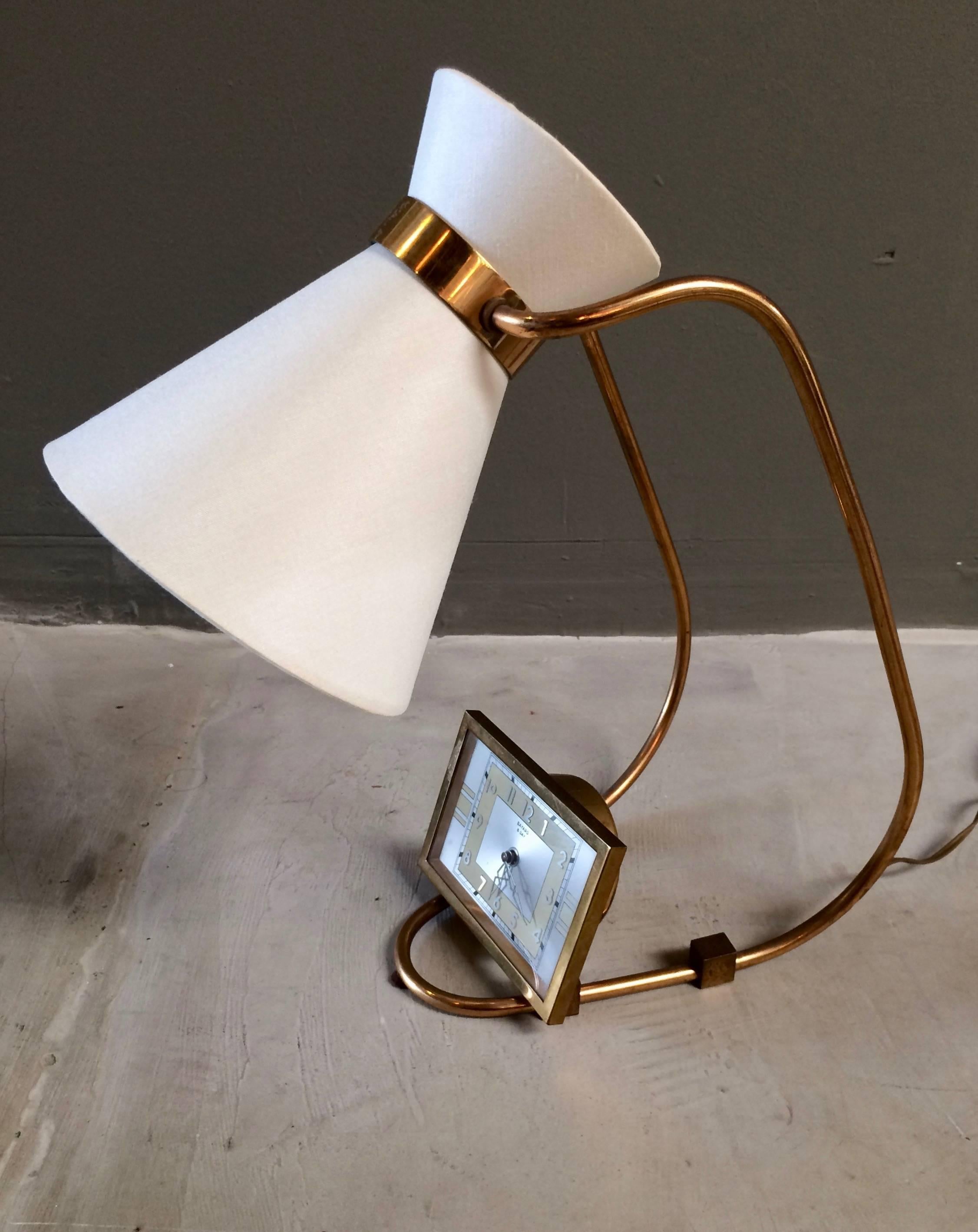 Great sculptural French lamp with built in clock by Bayard. Brass frame. New silk shades with adjustable light direction. Clock is in working order. Fantastic desktop piece. Perfect for a bedside table, nightstand or office desk.