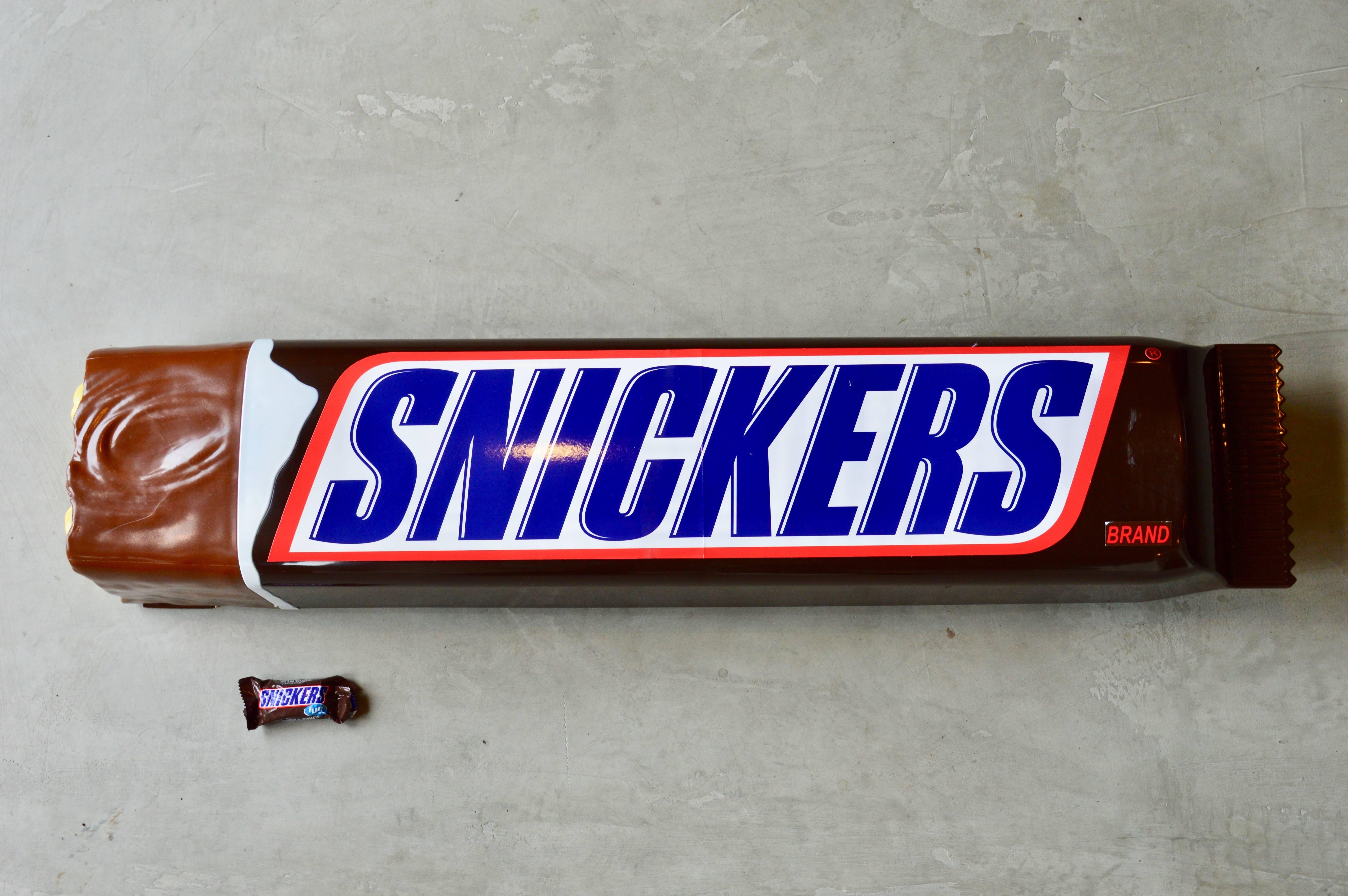 Cool oversized Snickers bar made out of plastic. Most likely a display piece made for stores. Three feet long! Great vintage condition.