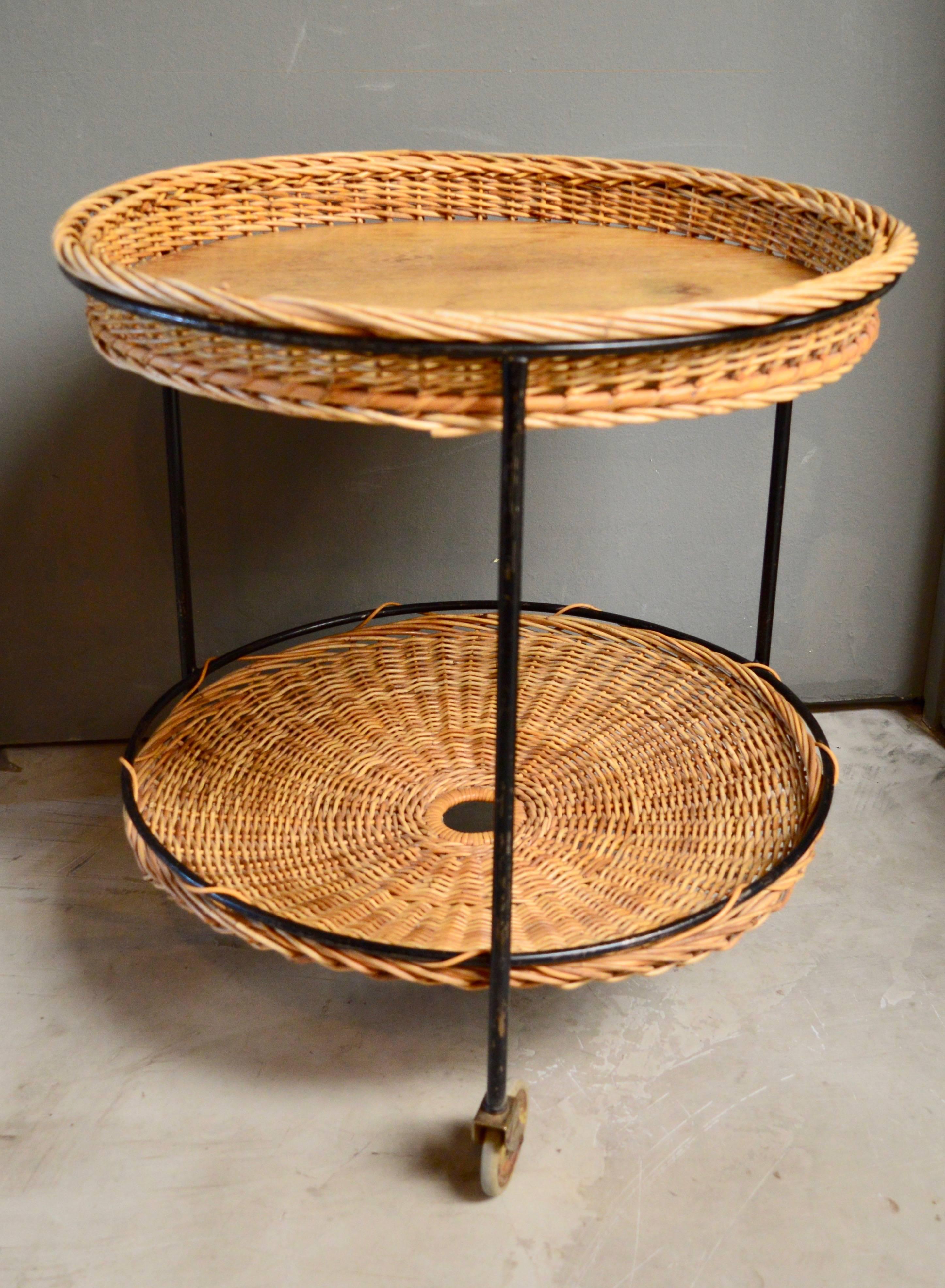 Charming French bar cart made of wicker and iron. Wood drink tray on top and wicker catchall on the bottom. Great vintage condition.