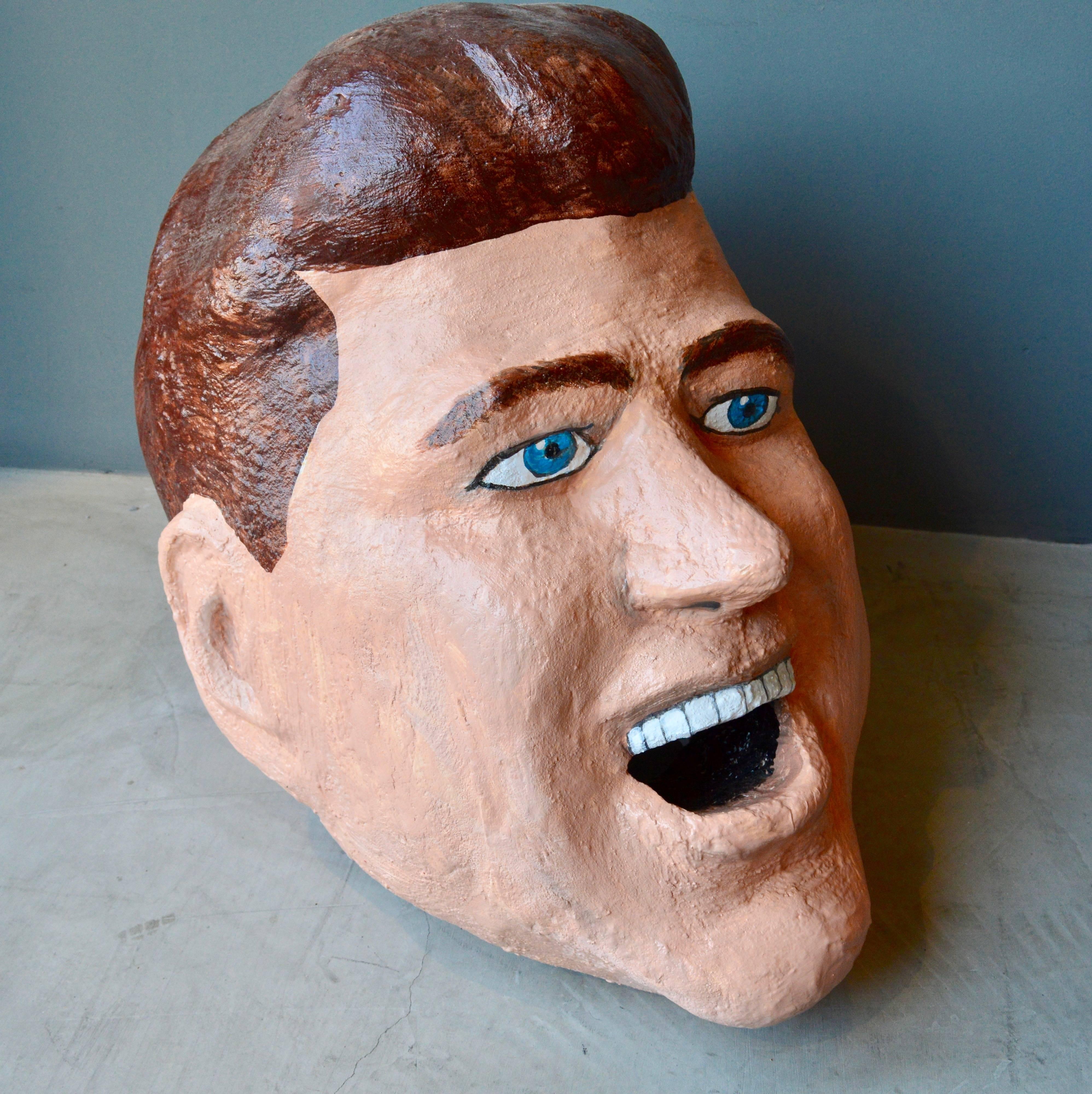 Monumental sculptural head of President John F. Kennedy. Made out of foam, paste and hand-painted. Able to be worn on the head. Looks great as a free floating sculpture. Clinton and George Bush also available (Nixon sold). Very unique object.