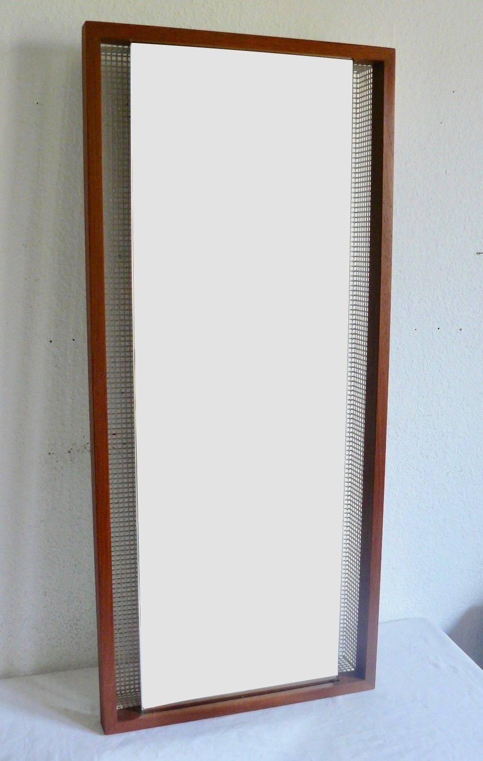 Handsome German backlit wall mirror. Teak frame with perforated metal backing. Six sockets. Illuminates beautifully. Looks great on and off. Perfect for a bathroom or an ambient piece of wall art.