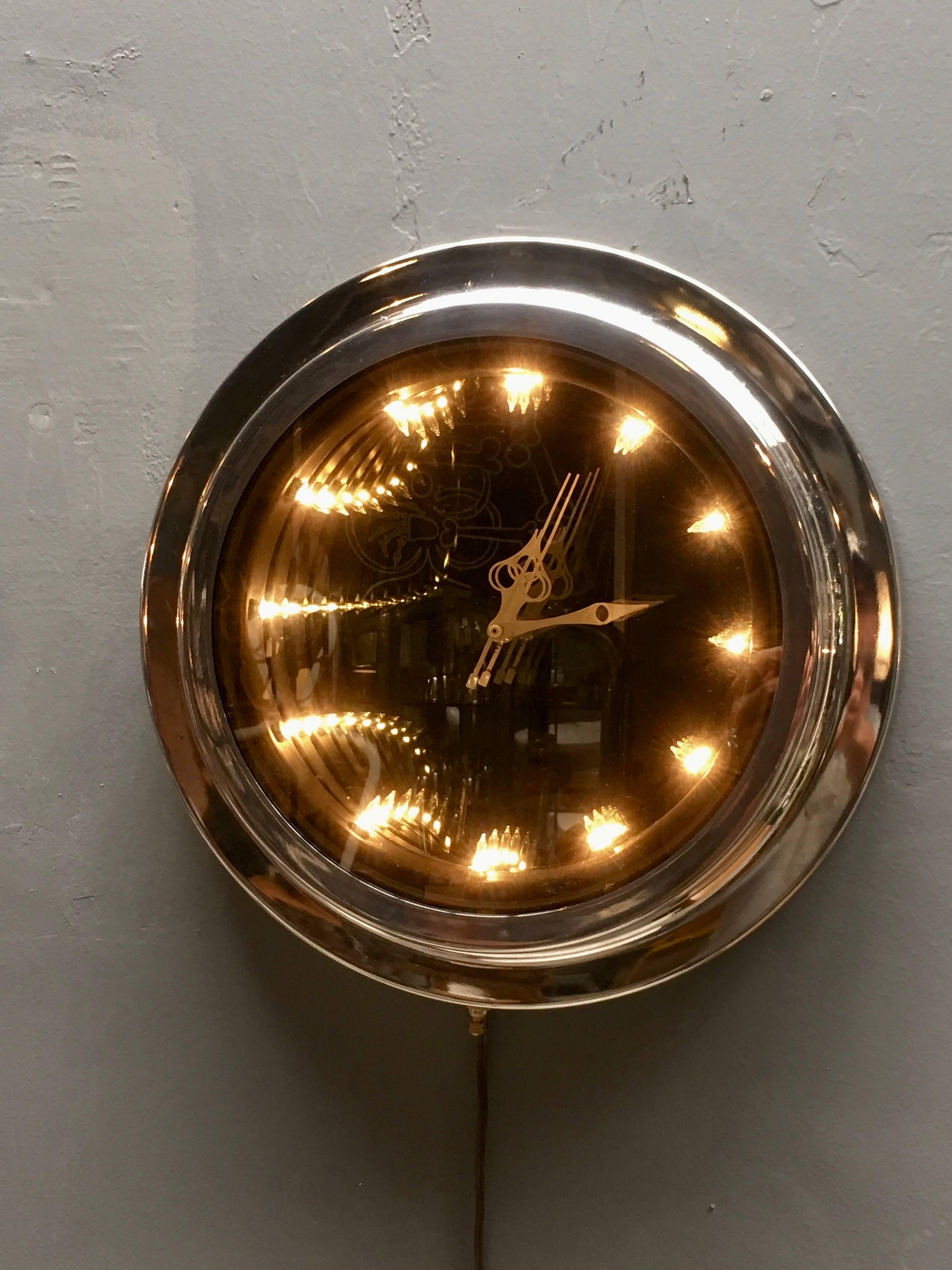 Super unique chrome infinity mirror from the 1970s. Built in clock. Clock is always running, and the infinity mirror can be turned on or off with a hand switch on the bottom of the piece. Great piece of wall art. Very good vintage condition. Newly