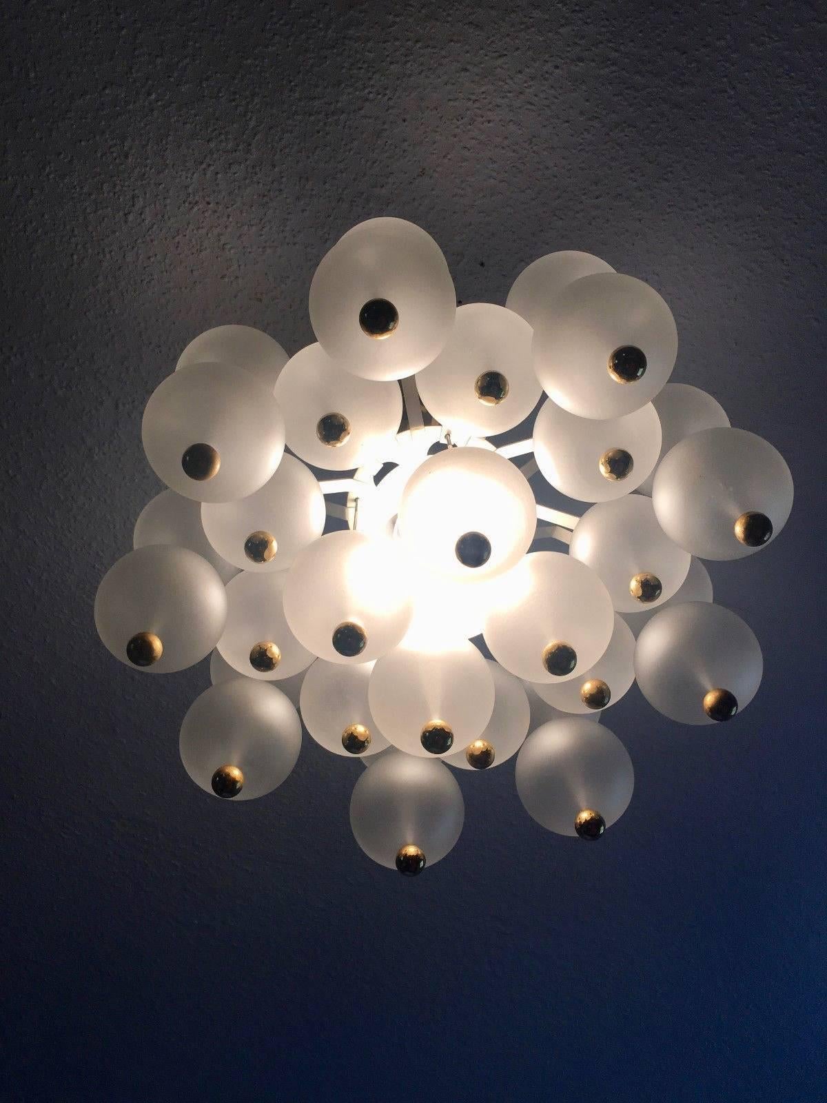 Gorgeous Austrian chandelier from the 1950s by Kinkeldey. Frosted glass globes with brass ball finials. Chandelier can be hung by brass stem or brass chain. Excellent condition. Overall height and choice of stem or chain will be covered by free of
