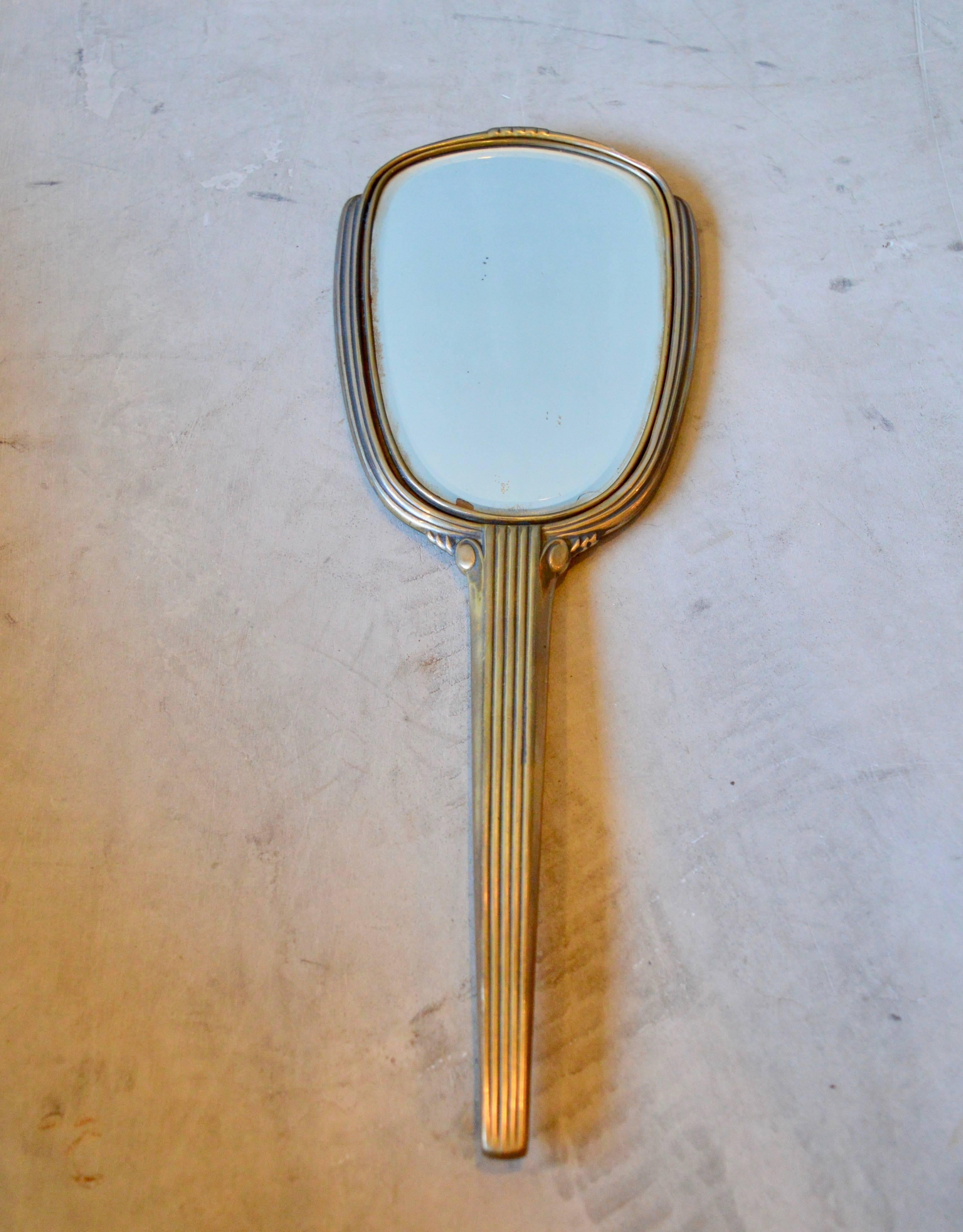 Beautiful Art Deco hand mirror. Brass with excellent patina. Very good vintage condition. Perfect addition to a vanity.