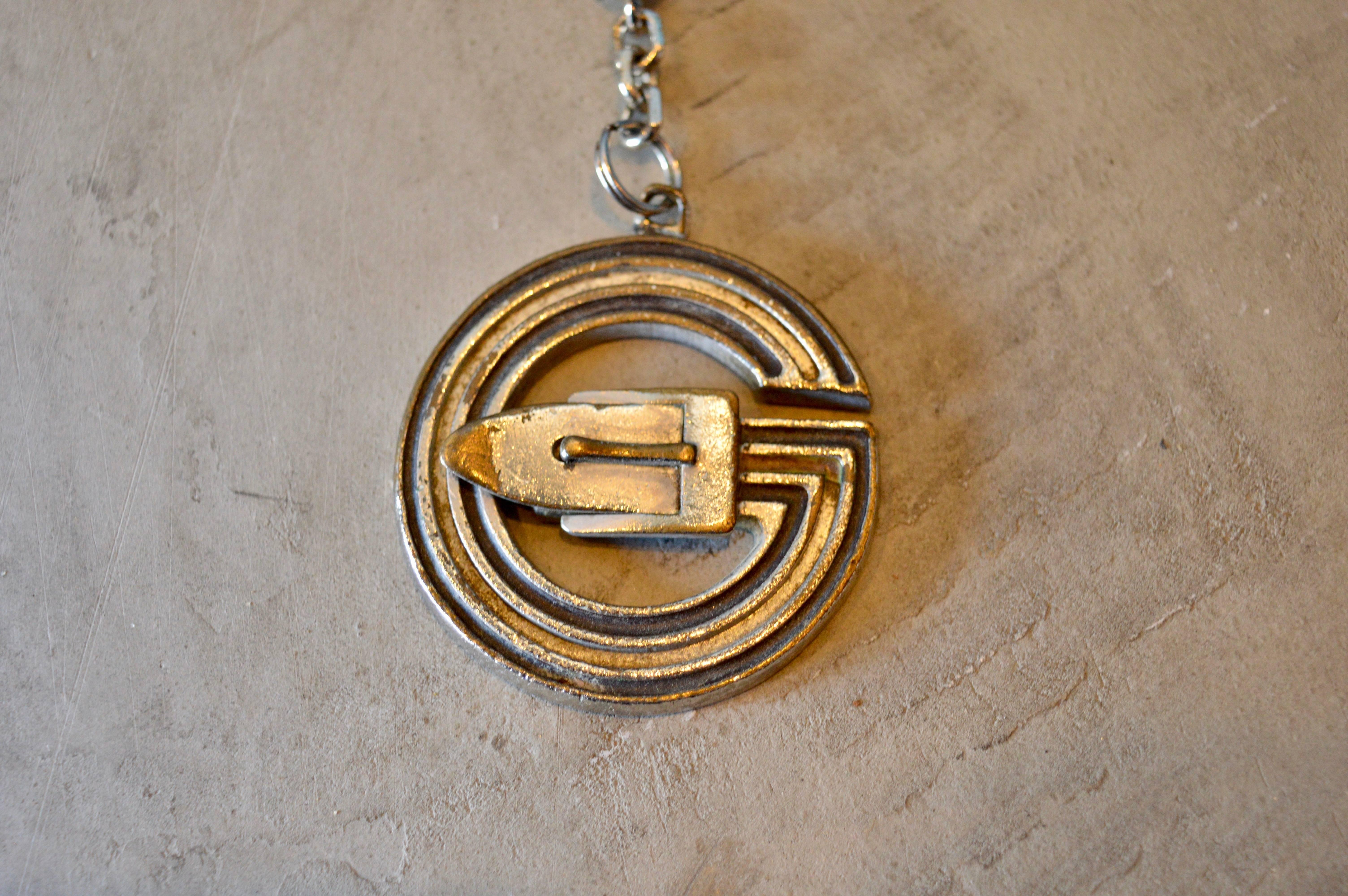 Cool vintage Gucci metal keychain. Great patina with large G - logo and belt buckle.