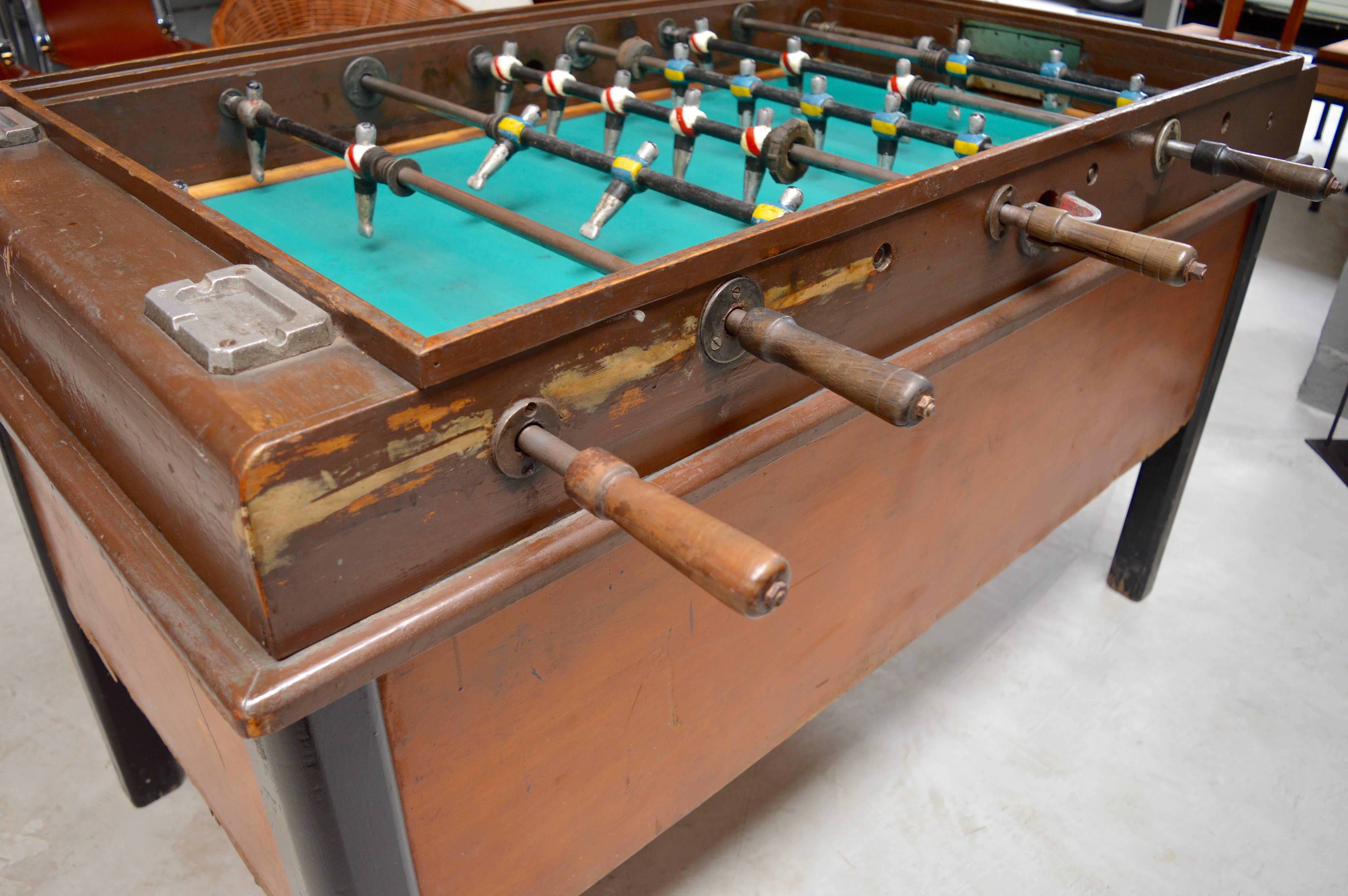 Great vintage Argentinian foosball table. Cast metal players and wood frame, circa 1940s. Black legs and great patina to wood. Great game table!