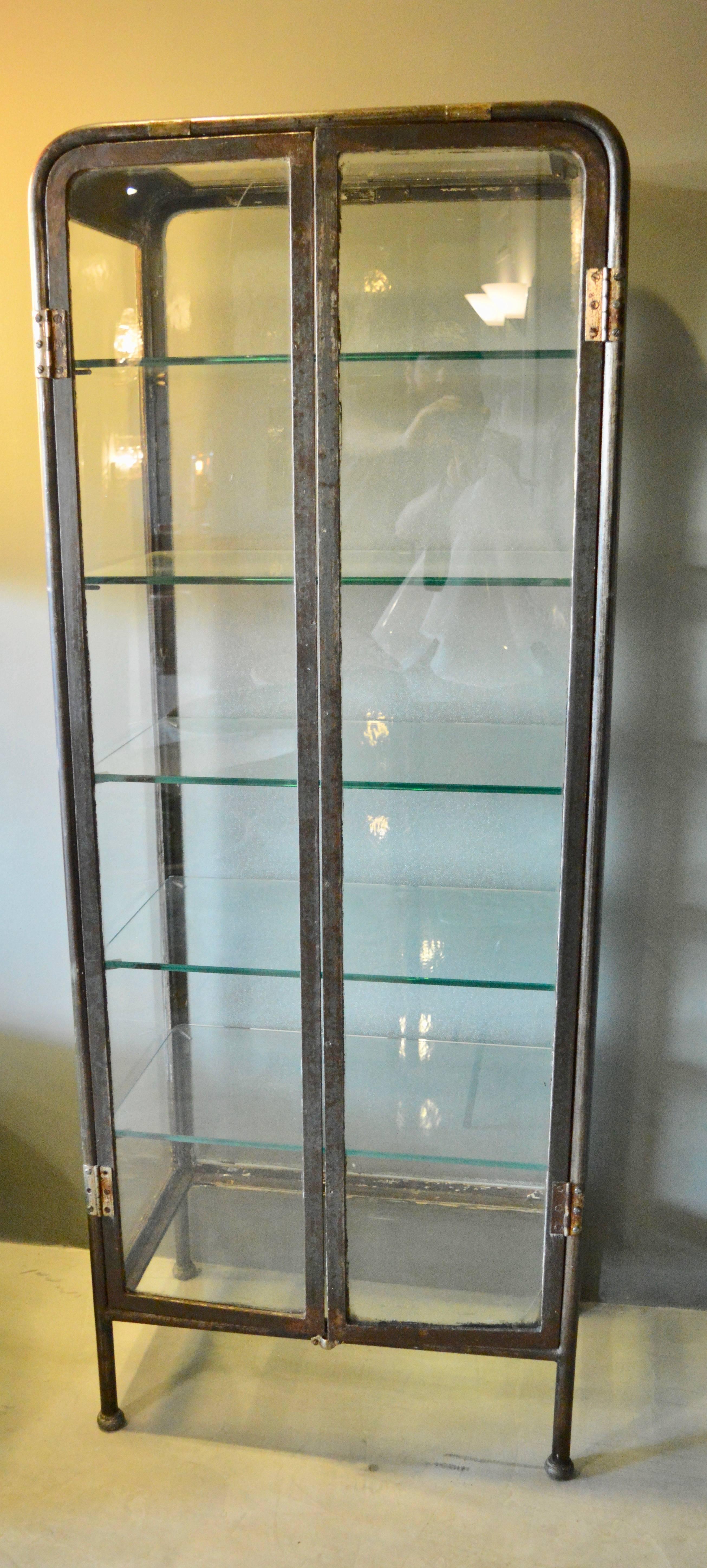 Handsome two-door iron and glass vitrine from Buenos Aires, circa 1930. Great patina to metal and in excellent vintage condition. Great display piece. Six other vitrines available in separate listings.