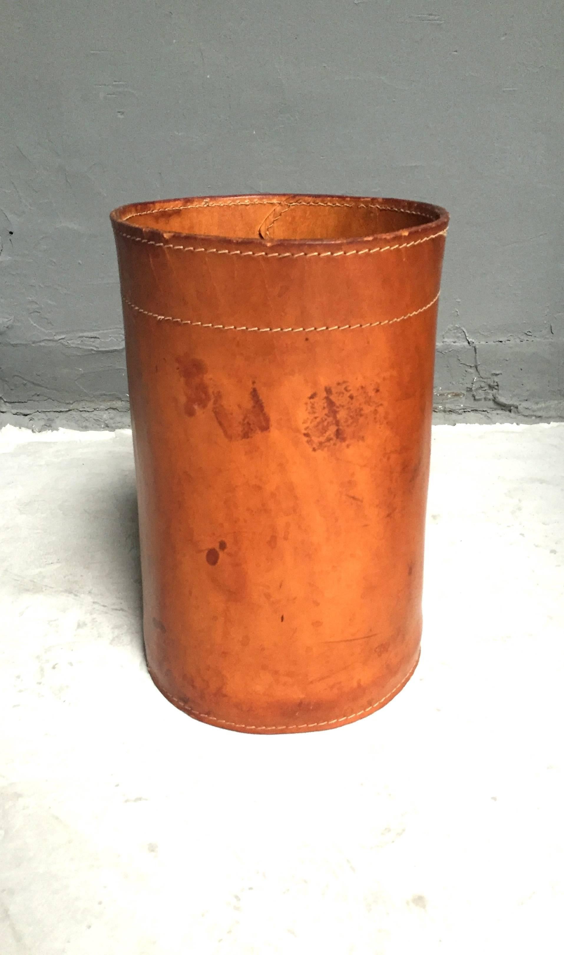 Handsome leather bin in the style of Jacques Adnet. Gorgeous patina to saddle leather. Fantastic piece!