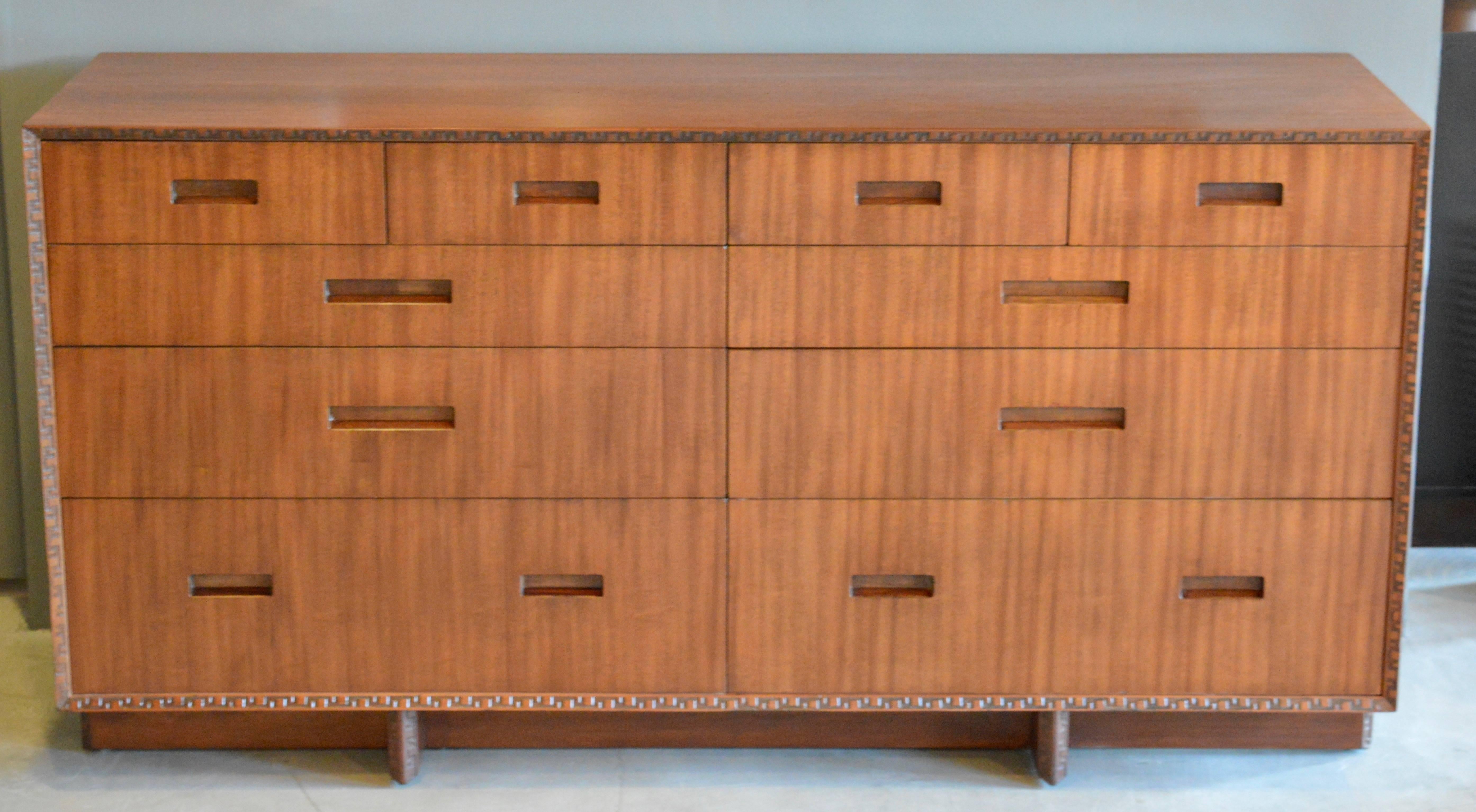 Gorgeous mahogany dresser by Frank Lloyd Wright for Henredon. This was part of the Taliesin collection. Six large drawers on lower half with four small drawers bordering the top. Great lines and classic design!

 