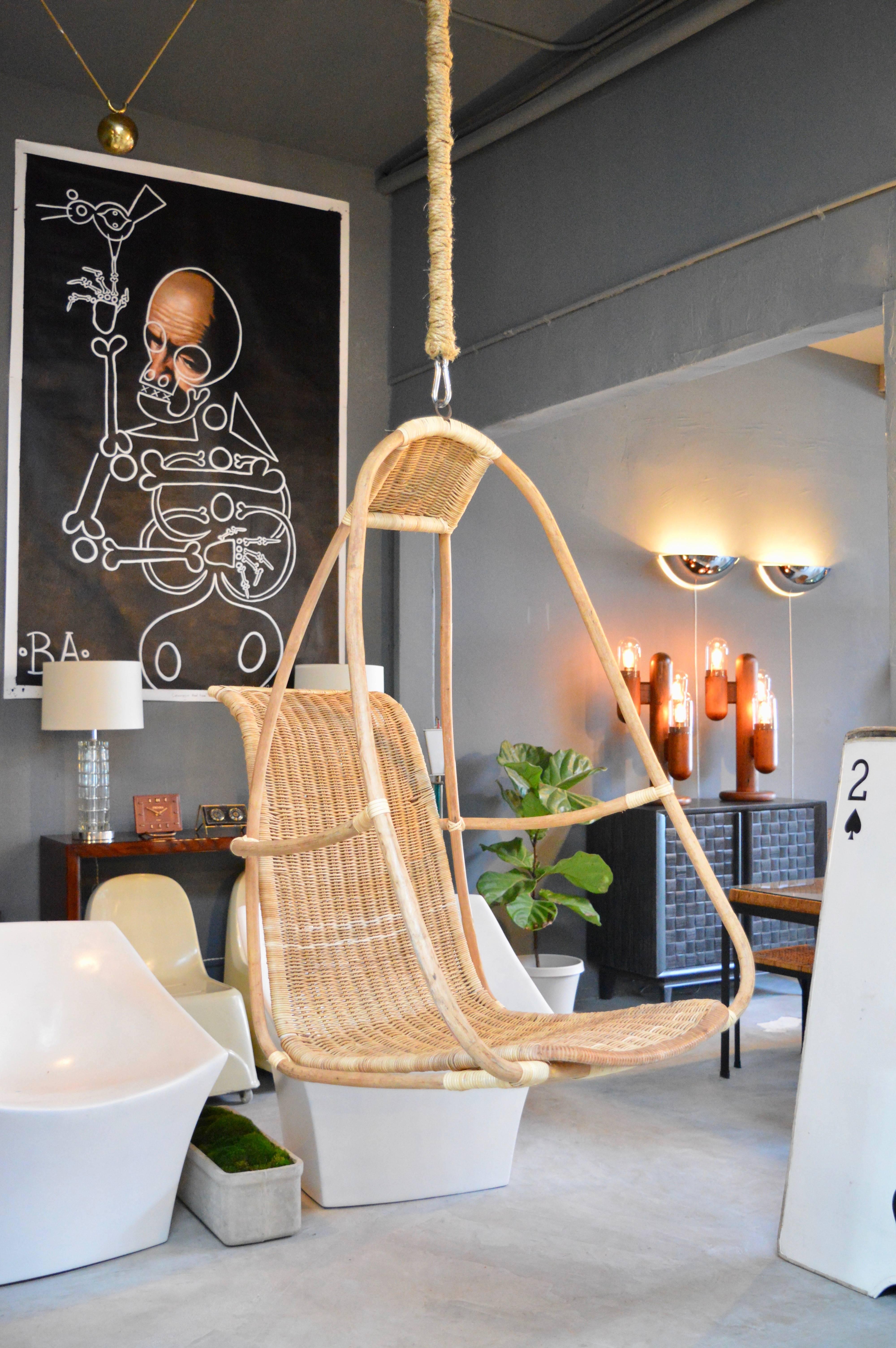 Great sculptural French bamboo and rattan hanging chair. Bamboo frame with rattan seat. Full sized seat with angular back allowing for great design and comfort. Excellent vintage condition. Steel chain wrapped in rope twine included in purchase.