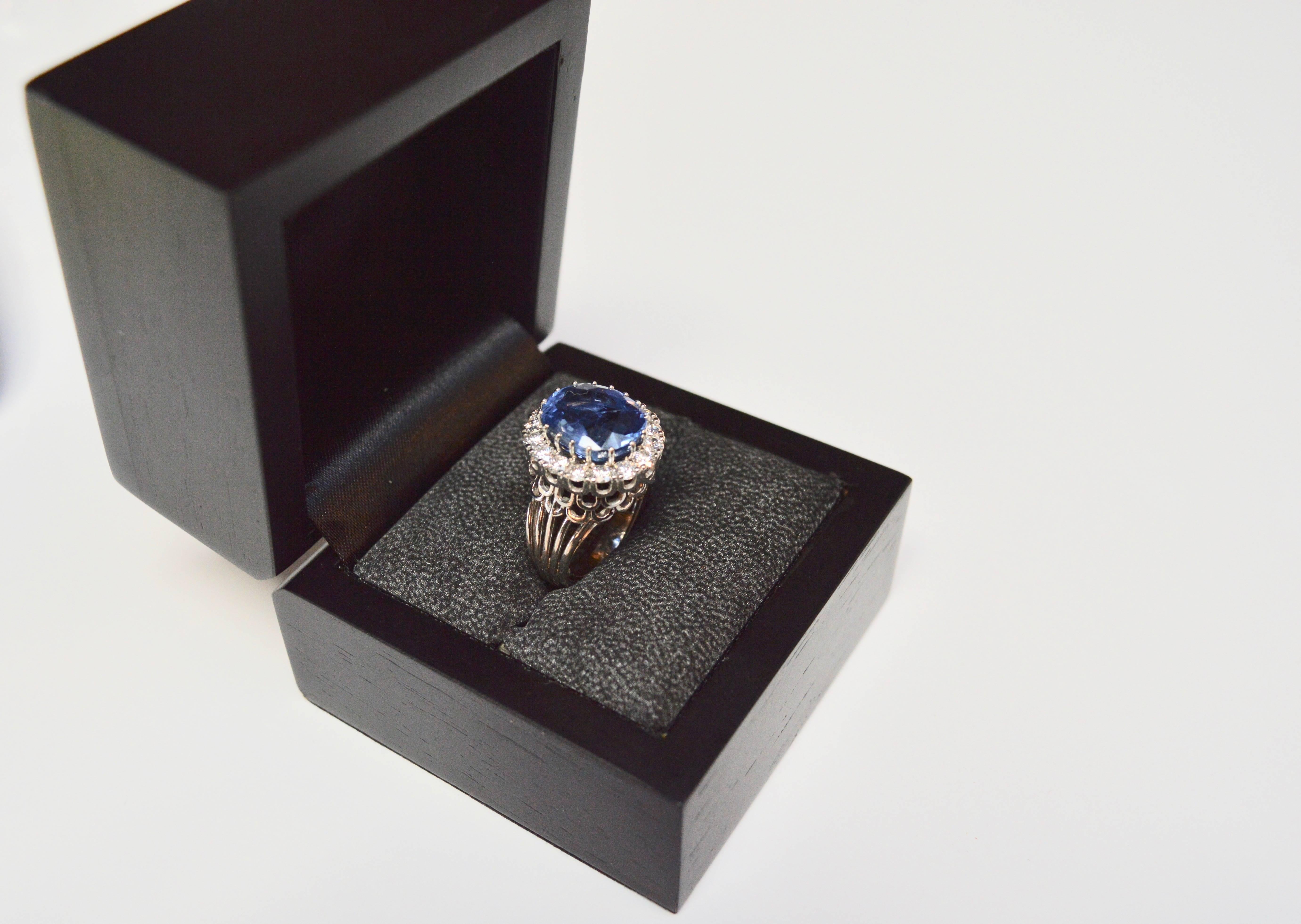 Stunning vintage handmade Sapphire and diamond ring on a platinum band/setting. Oval shaped mixed cut, natural Sapphire approximately 9.1-carats. Medium blue color, moderately included, good cut. No treatment to stone. Along with 16 full cut round