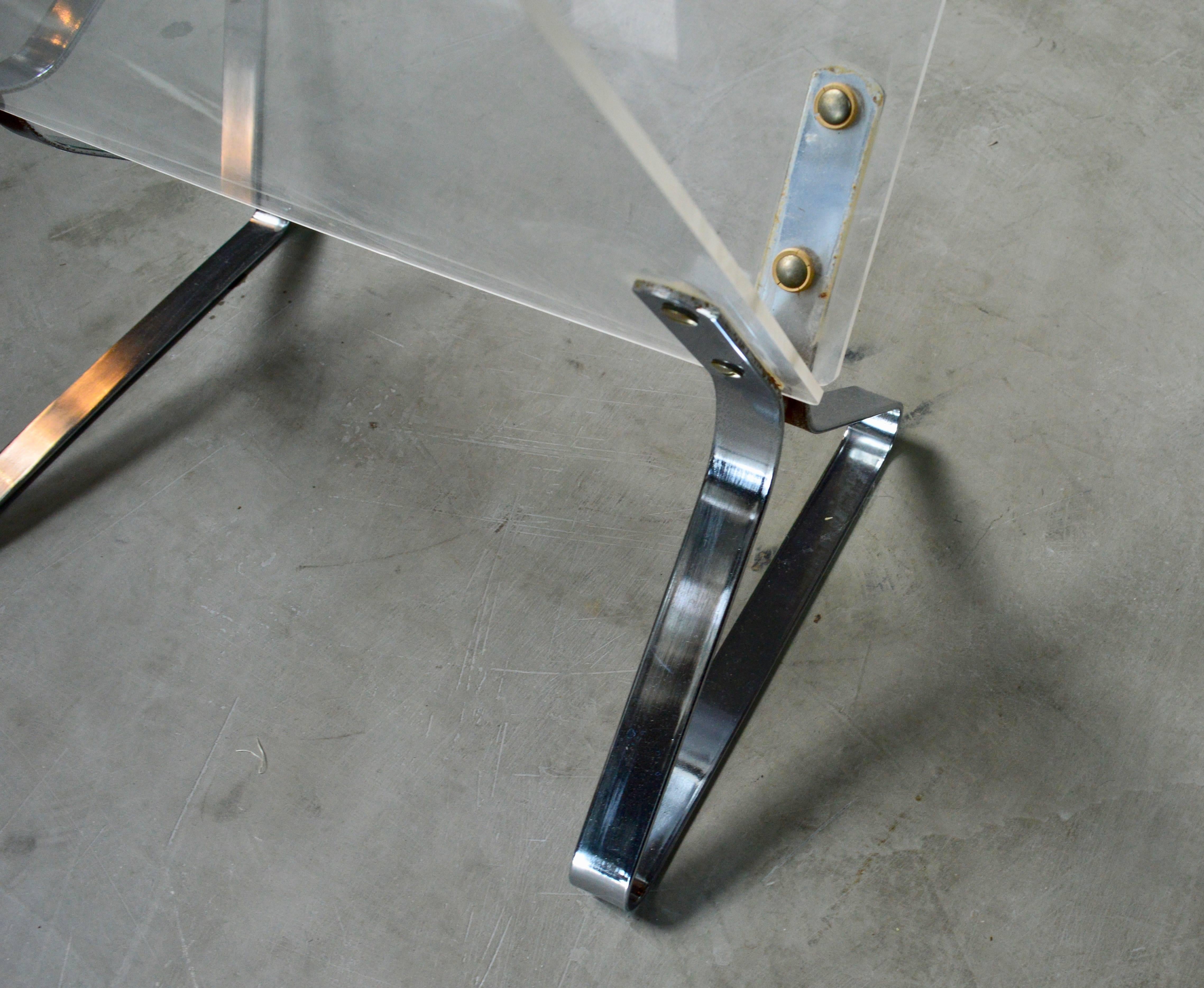 Excellent Lucite and chrome magazine stand. Two available. Priced individually. Great vintage condition.