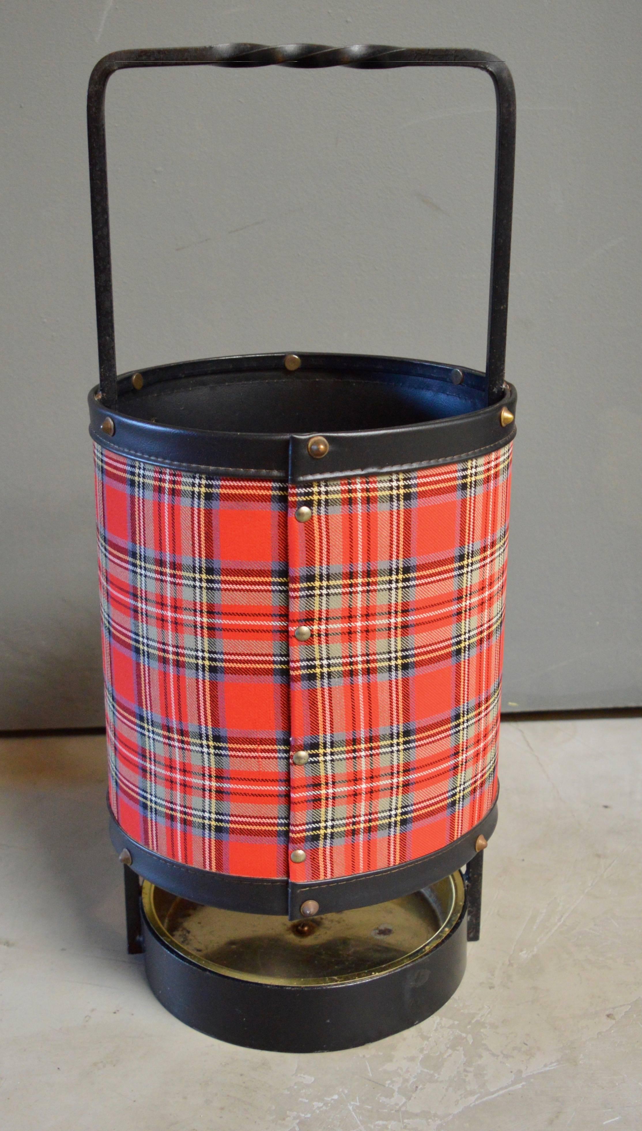 Handsome leather and iron umbrella stand by Jacques Adnet. Iron frame with stitched leather and plaid. Brass dish inside to catch water. Excellent vintage condition. Matching umbrella stand with slightly different plaid available in separate listing.