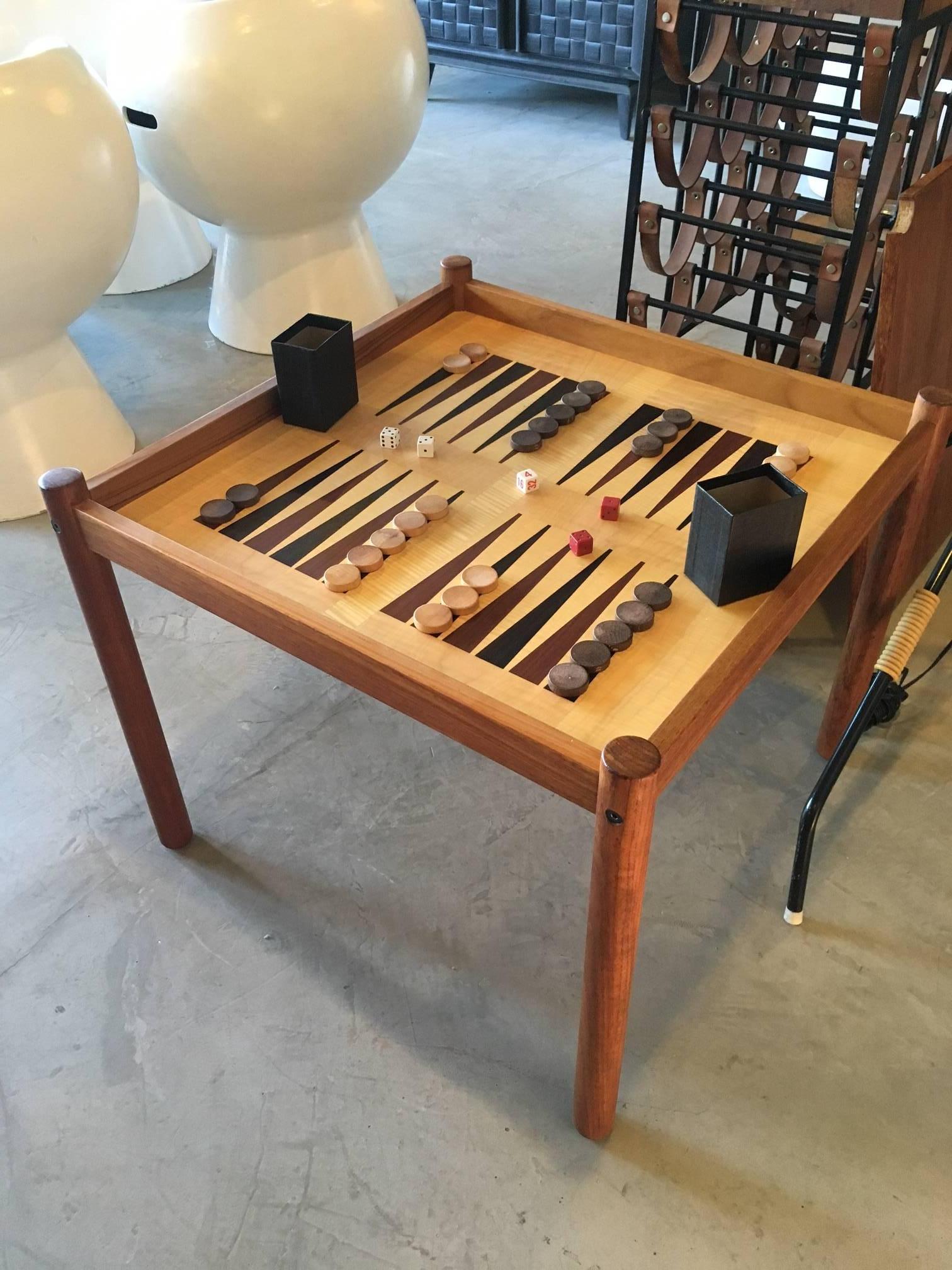 Excellent teak backgammon game table. Made in Denmark by Georg Petersens. Original label underneath. Backgammon table or chess board and finished side as well. Perfect side table between two club chairs. Big enough to be a standalone backgammon