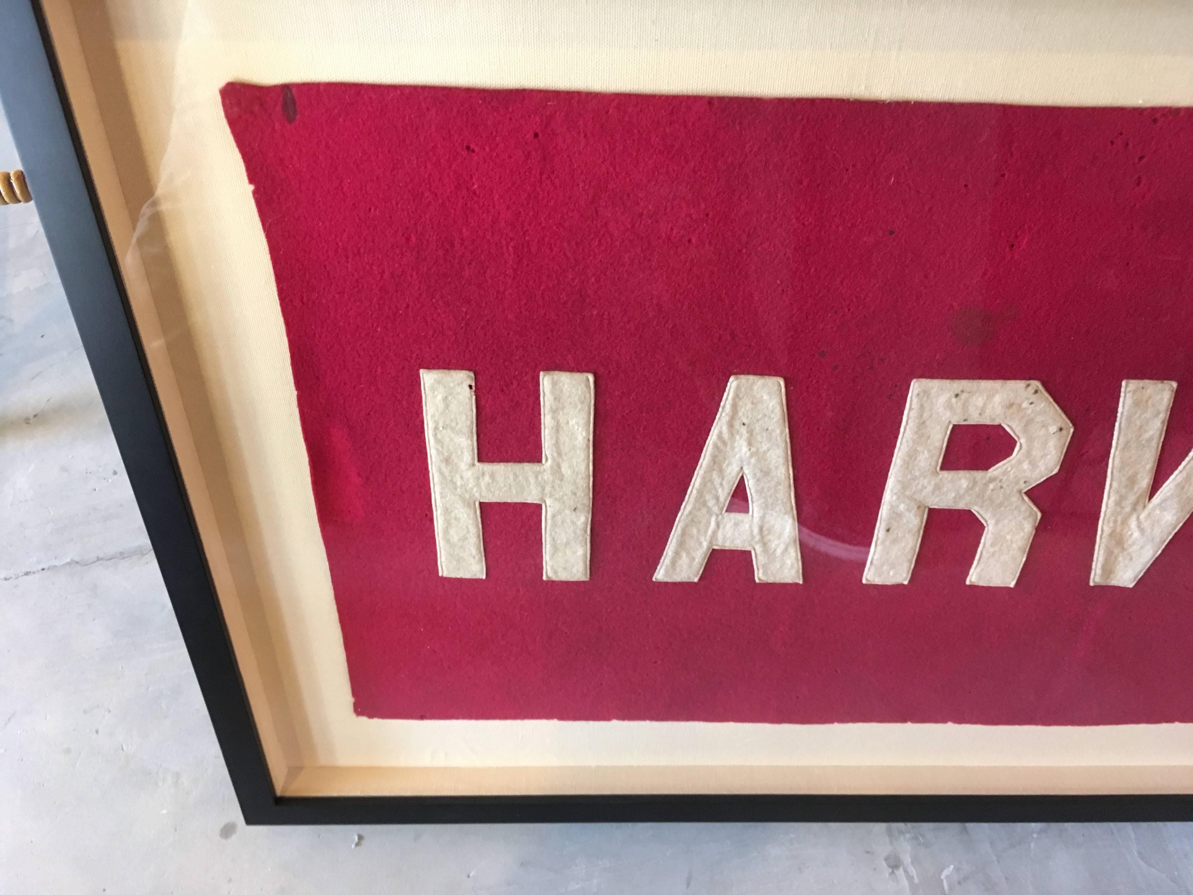 Unique Harvard University school banner from the 1930s. Great piece of Americana. Original red and white coloring with great patina. Hand stitched. Newly framed and mounted on linen backing.

Dimensions of banner are 15.5