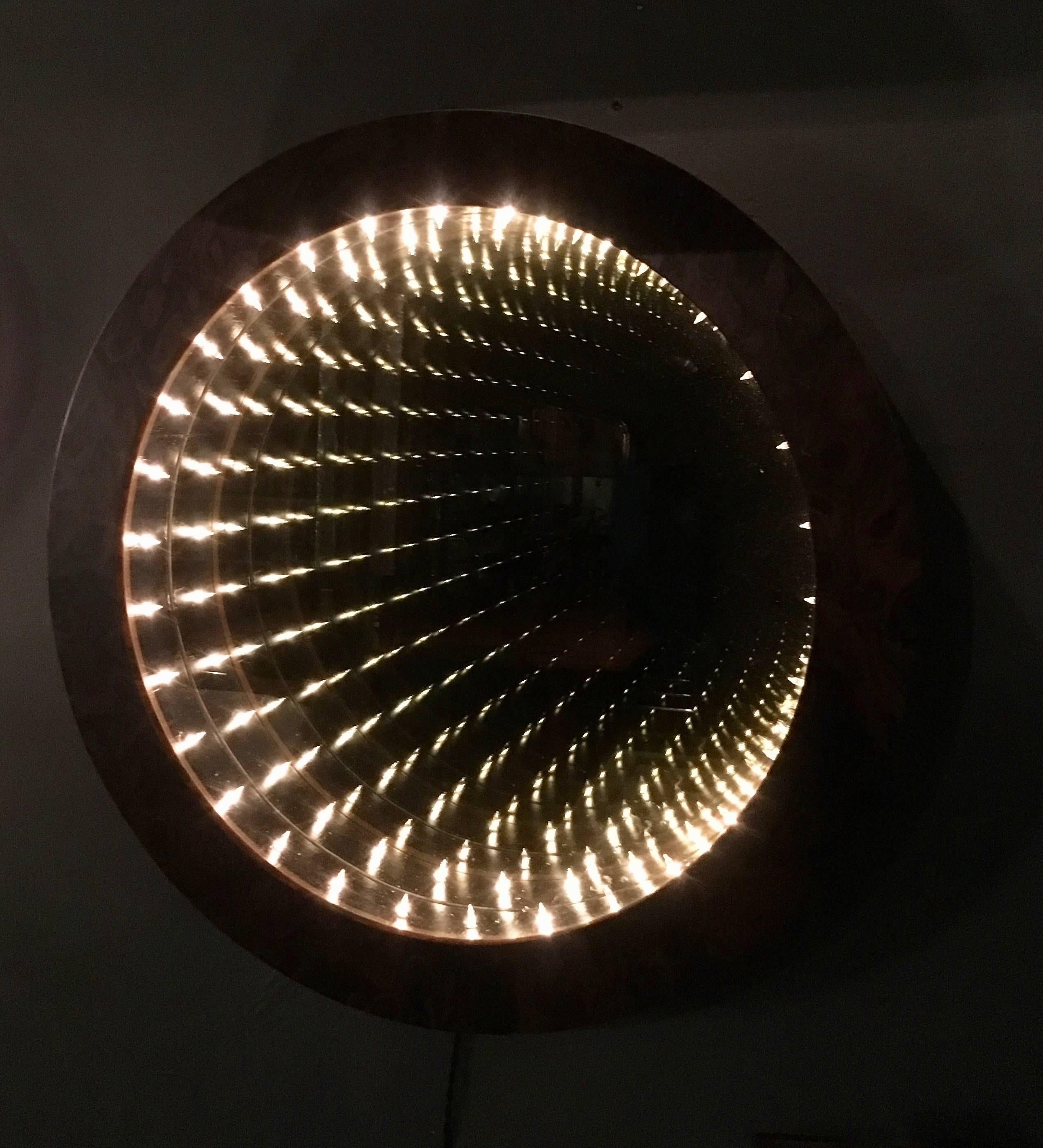 Stunning circular infinity mirror by Merit. Burl wood frame mirror looks great off as well as an ambient light and piece of art while illuminated. 

Custom sizes and finishes available.