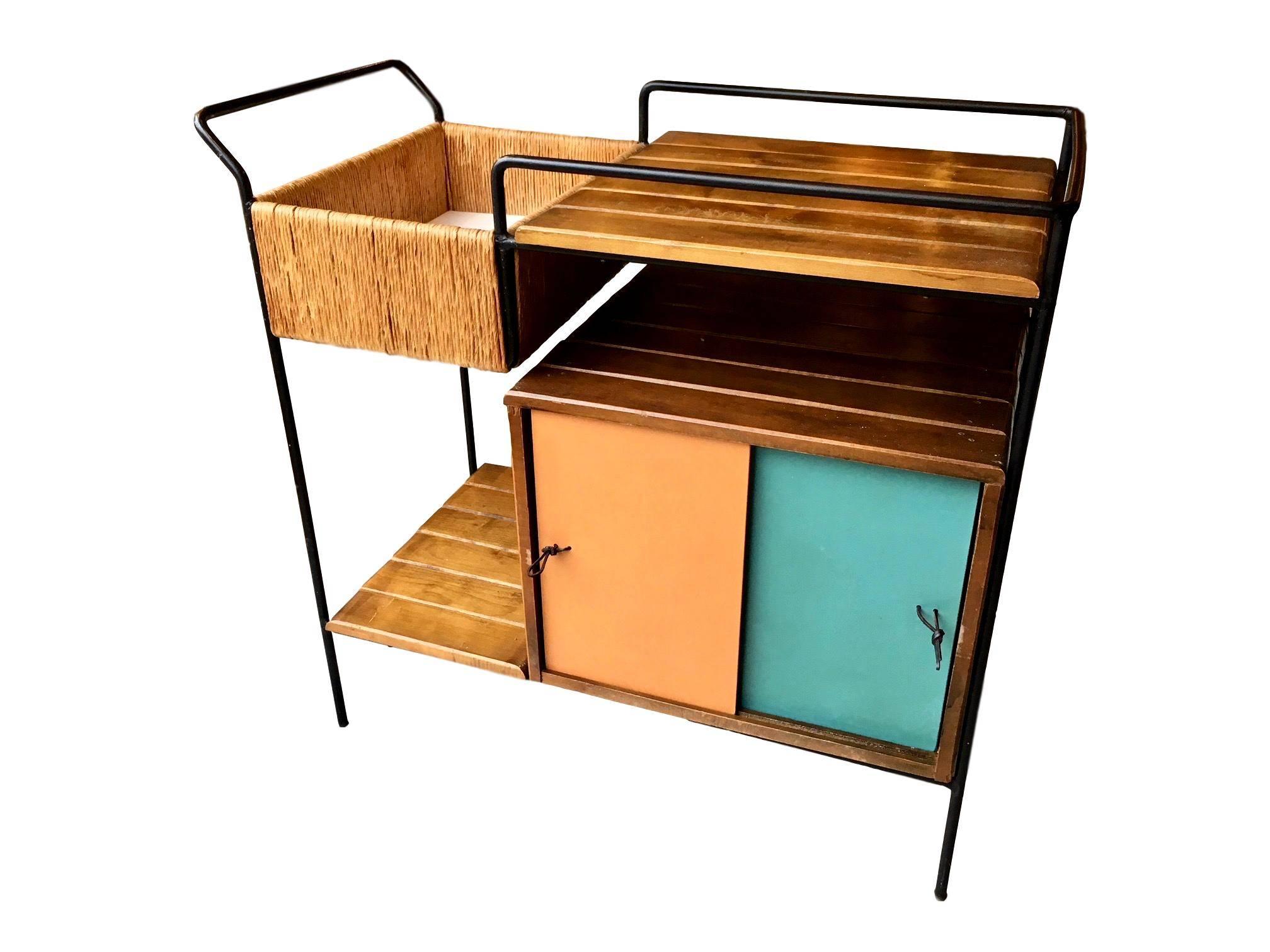 Classic bar cart by Arthur Umanoff. Aged iron frame with rush trim and slatted wood. Four blue and off-white sliding doors flank both sides of cart. Leather pulls on doors. Can be used with or without casters. Excellent vintage condition.